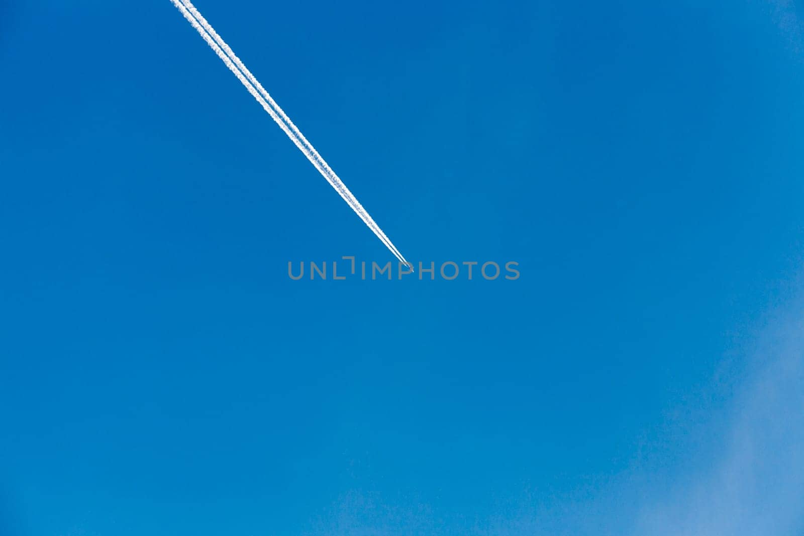 photographed close-up of a blue sky with clouds located on it, flying plane