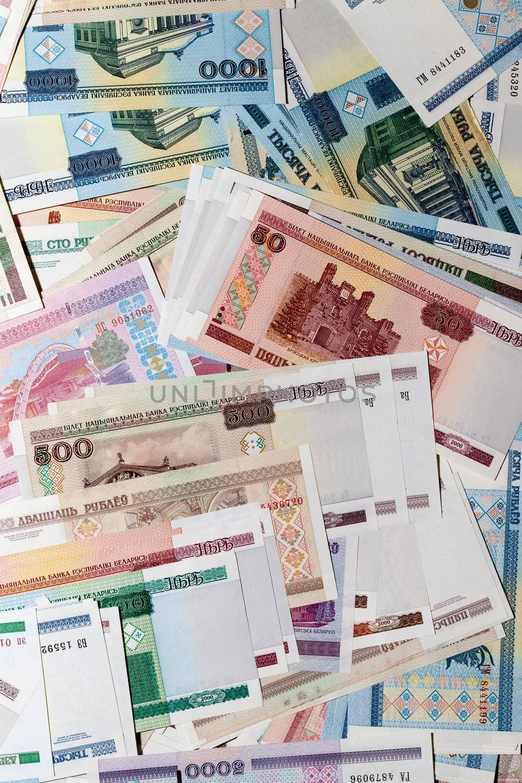 photographed close-up of the Belarusian money lying in a large pile of old and new banknotes