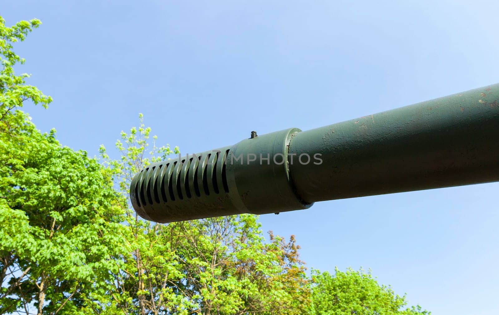photographed close-up of the gun barrel, situated on an old military equipment. tank for fighting