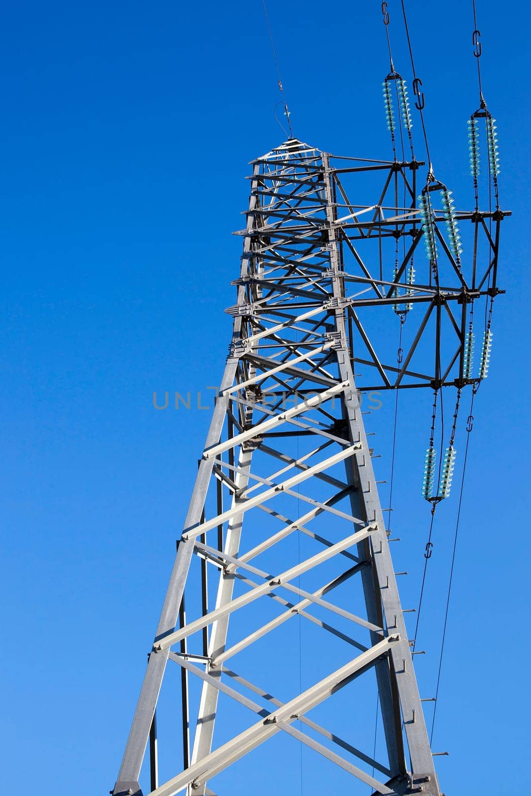 photographed electric poles situated in the daytime, industrial buildings