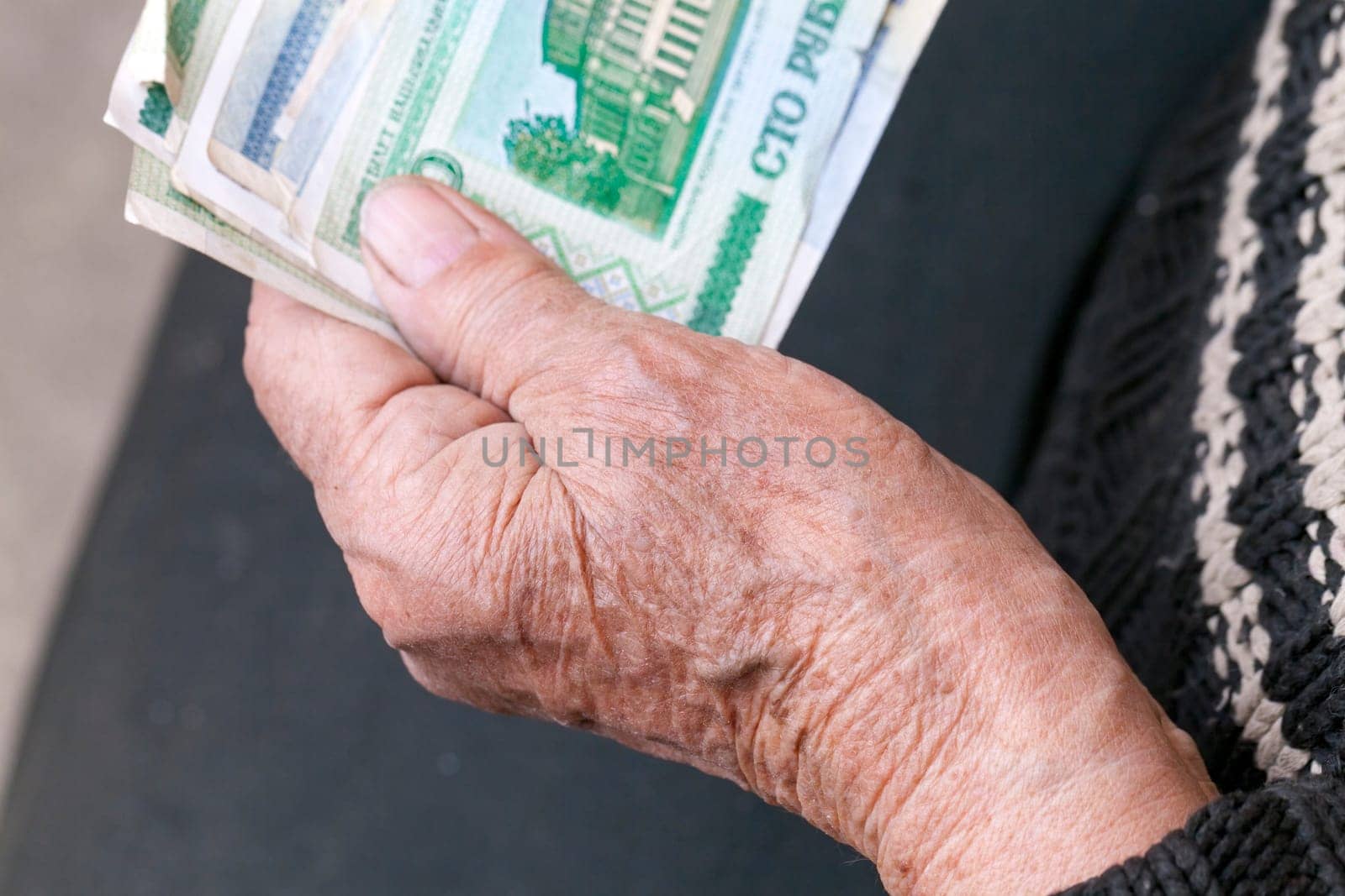 Belarusian rubles, which is holding an elderly woman pensioner