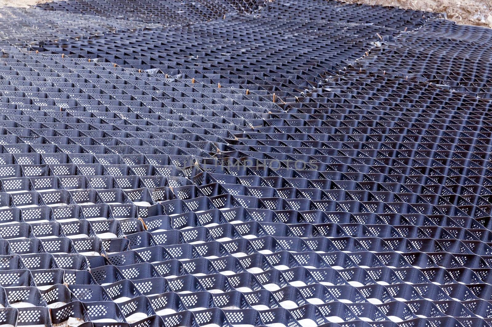 plastic fences black used in the Construction of the building to keep the sand. Photo closeup of a hill