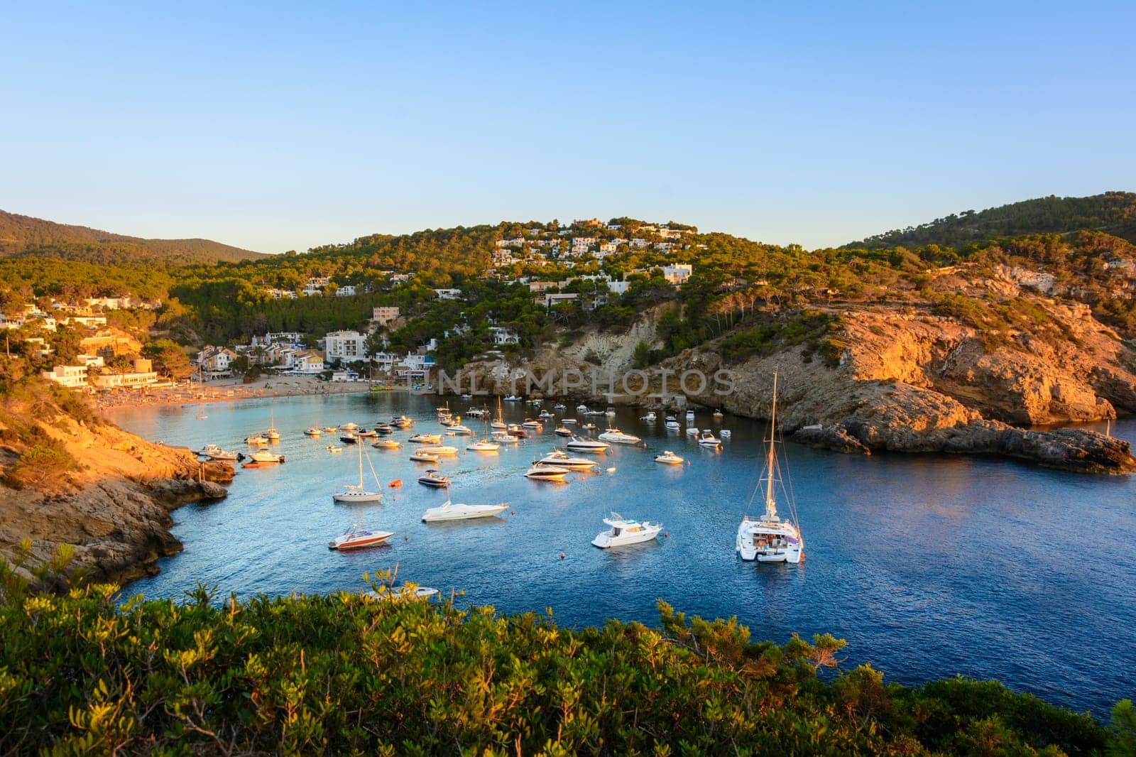 Sunset in the small bay of Cala Vedella, Ibiza island. Part of Balearic islands in Spain