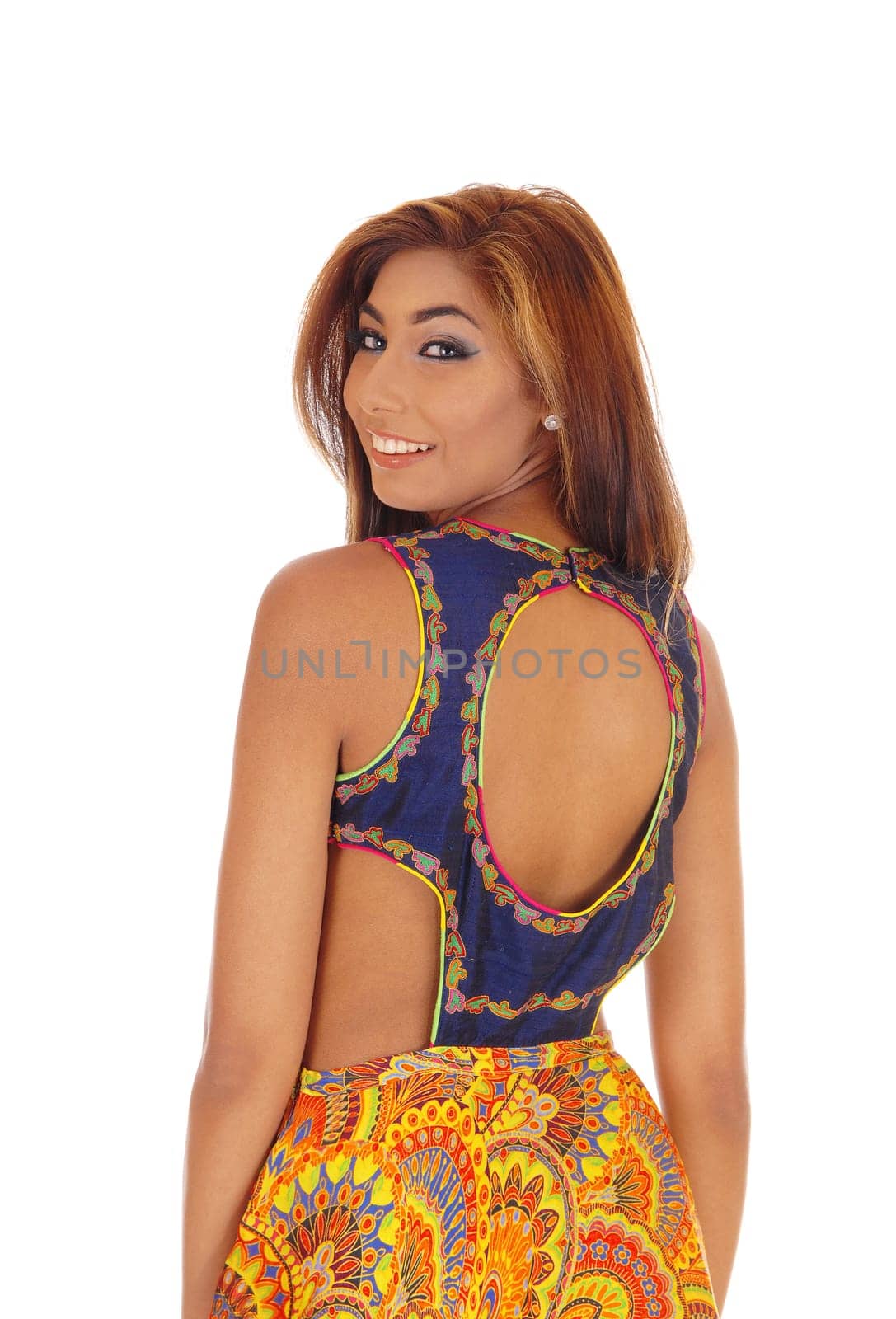 A Gorgeous Caucasian woman in a designer dress standing waist up .isolated for white background, looking over shoulder..