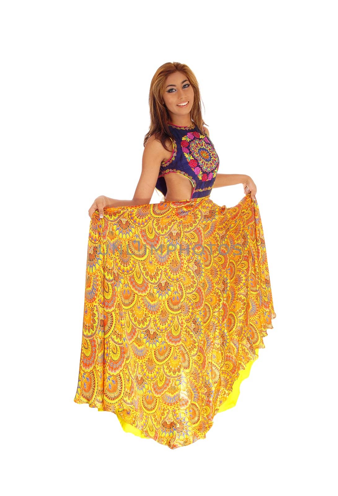 A beautiful young woman standing in a long yellow skirt, lifting it up,.isolated for white background..