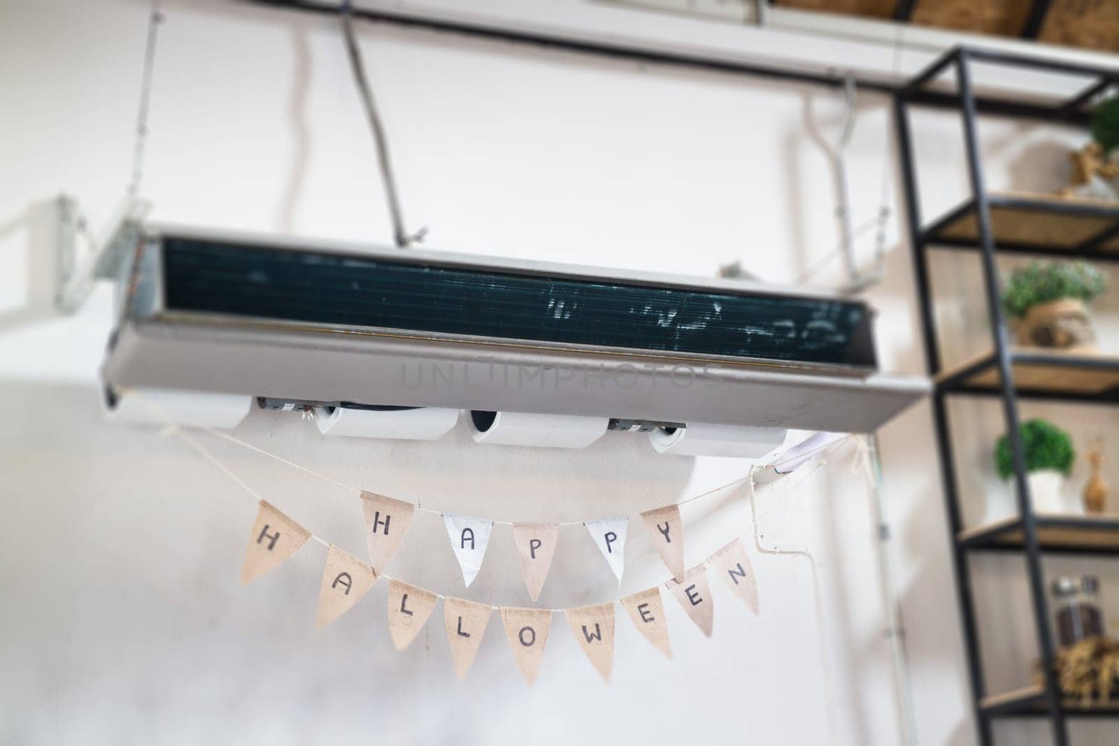 Hanging air conditioner and Halloween flags, stock photo
