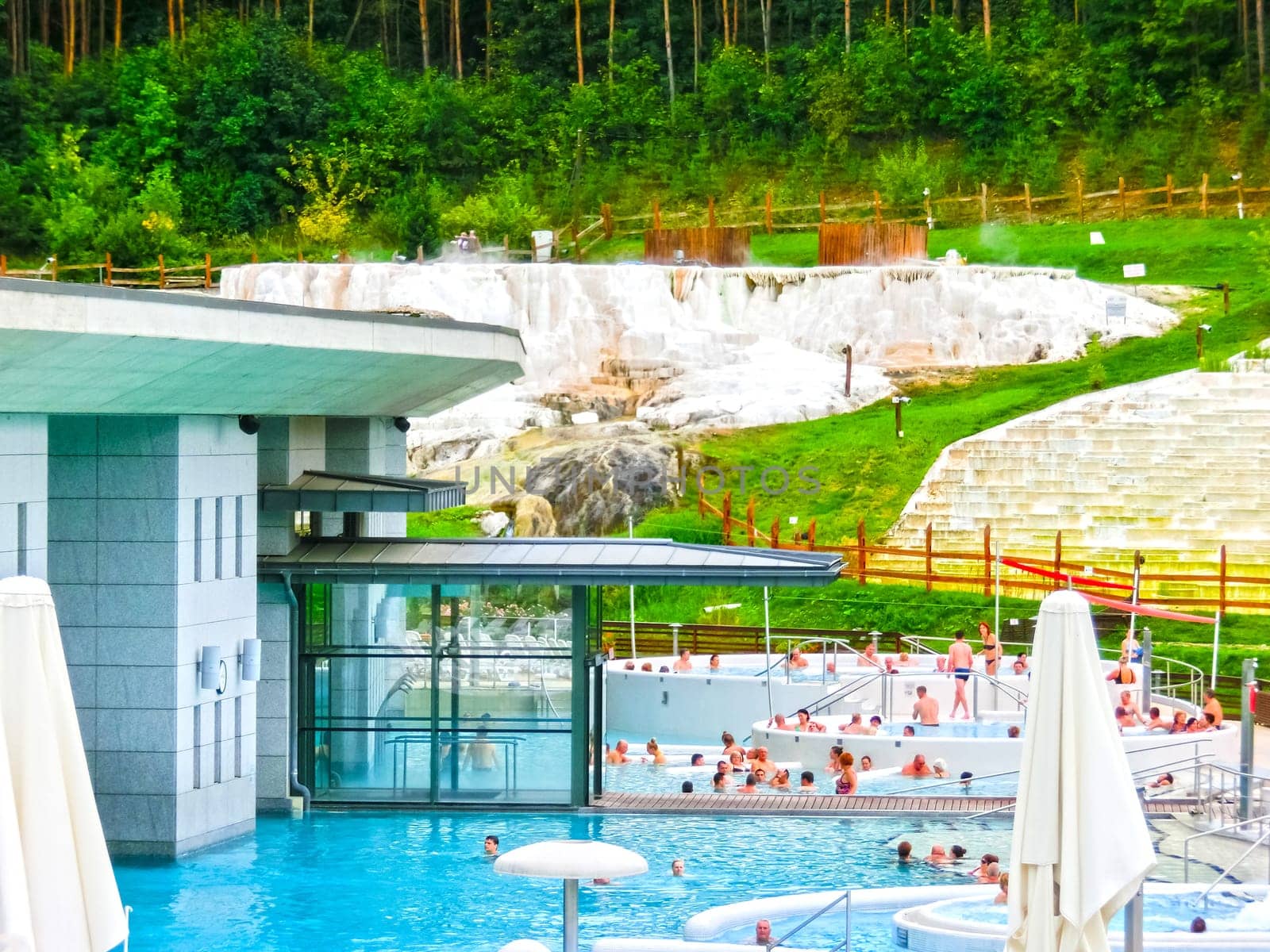 Egerszalok, Hungary - September 27, 2015: People resting in hot water pools of the Saliris resort. The Egerszalok spa pools contain water rich in calcium, magnesium, and hydrocarbonate minerals.