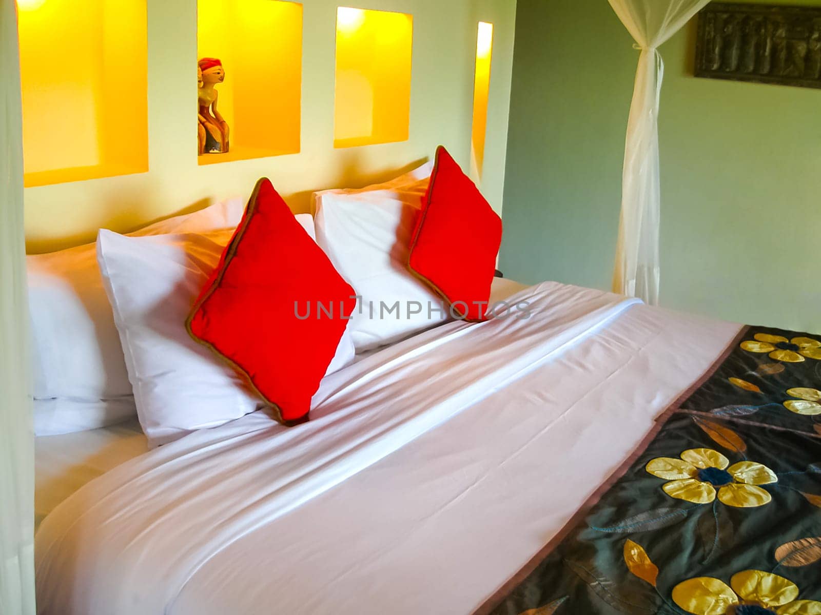 Bali, Indonesia - April 13, 2012: View of bungalow with bed at Nandini Bali Jungle Resort and Spa.