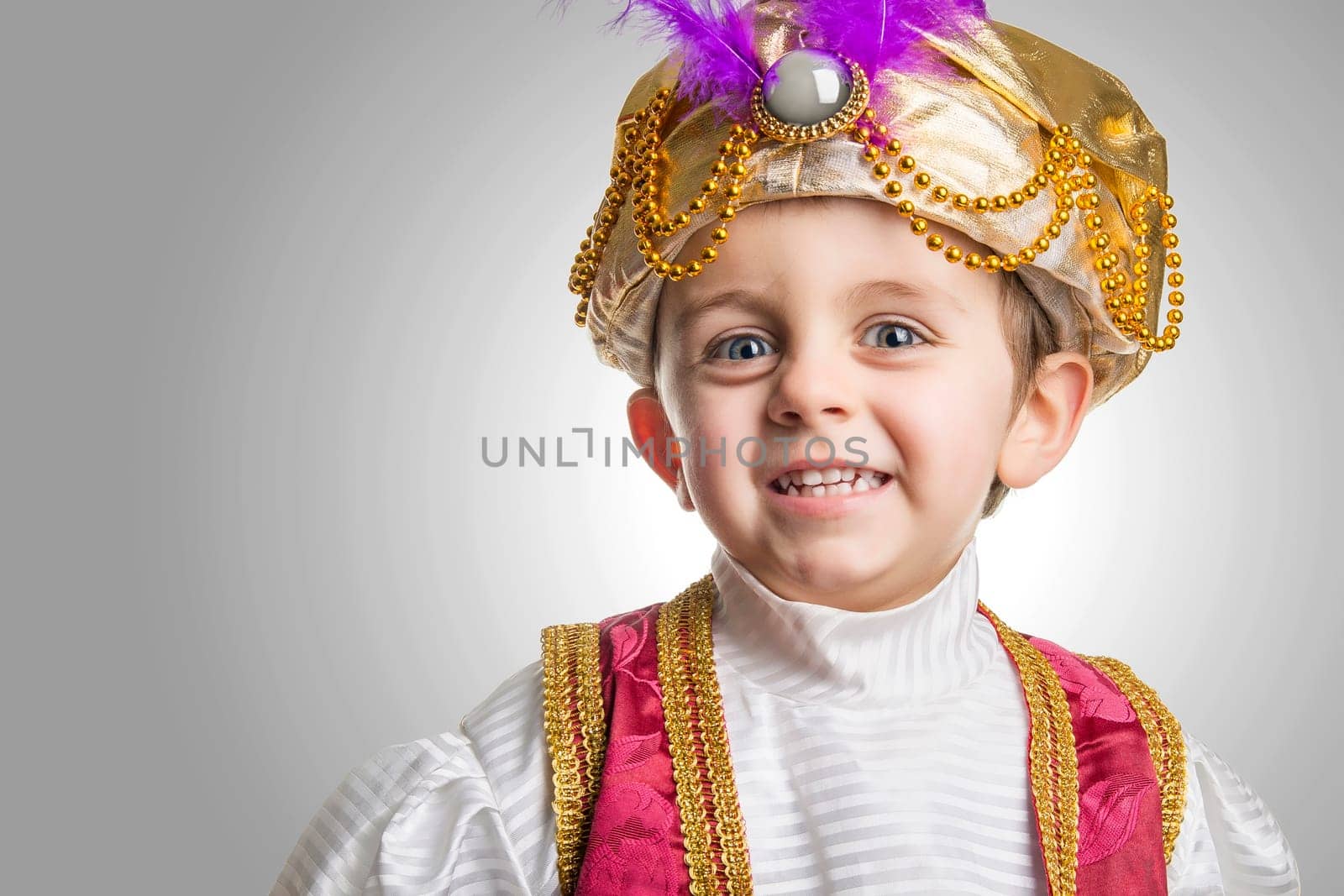 Child smilling in sultan costume.