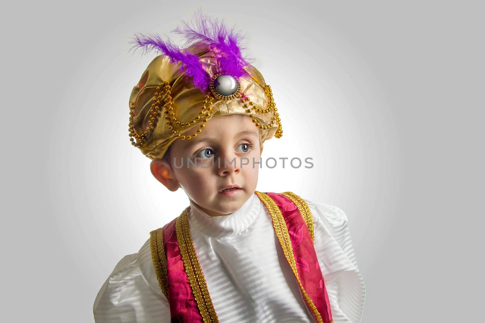 Child posing in sultan costume.