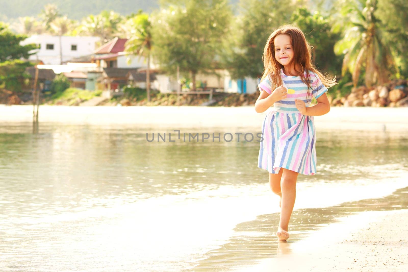 Adorable little girl have fun on the beach