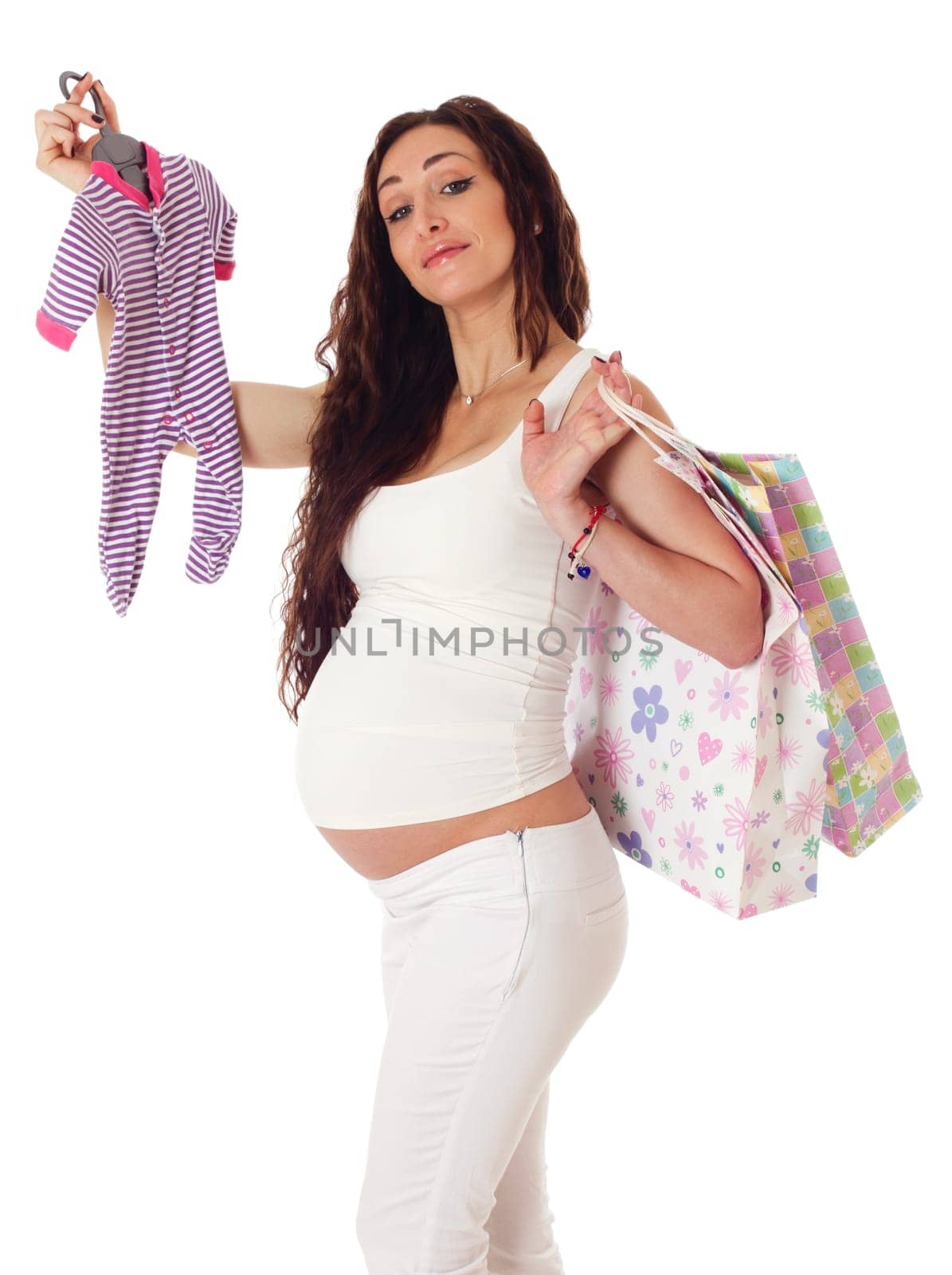Portrait of a pretty pregnant woman with baby clothes and shopping bags over white background.