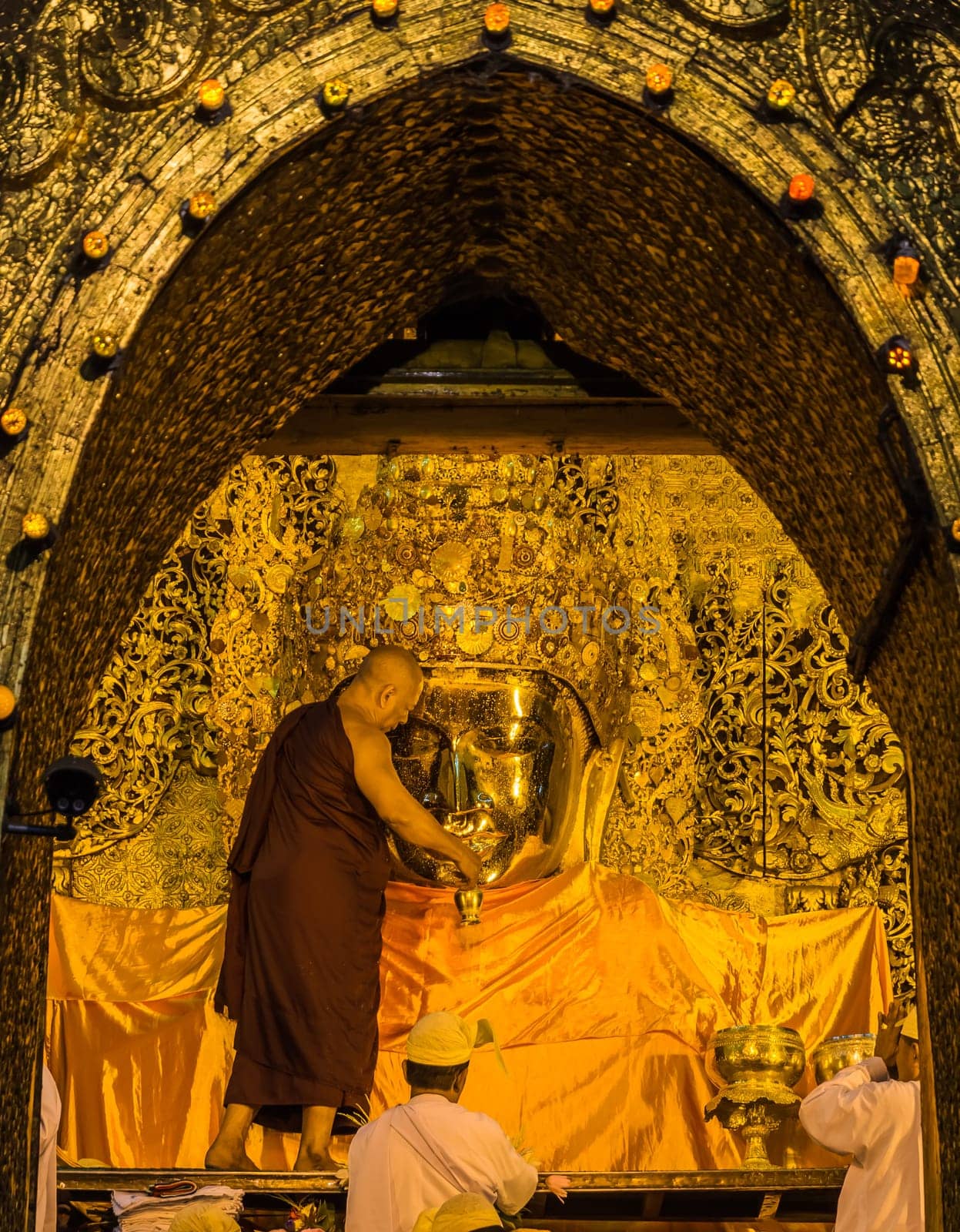The ritual of daily face washing Mahamuni Buddha in Mandalay, Myanmar