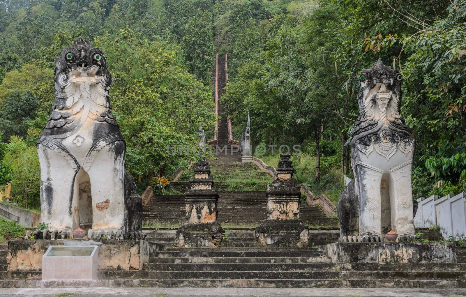 Burmese sculpted lions statue at stairways leading up to the hill at Wat Phra Non in Mae Hong Son, Thailand