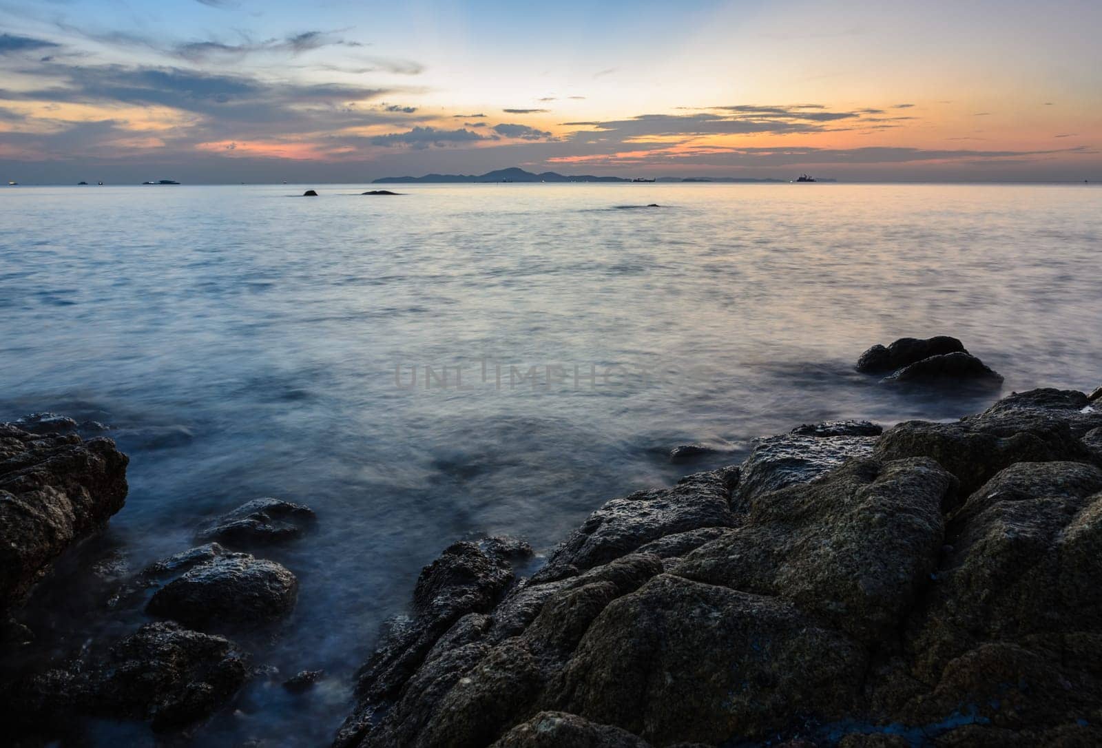 Rock beach sunset skyline afterglow