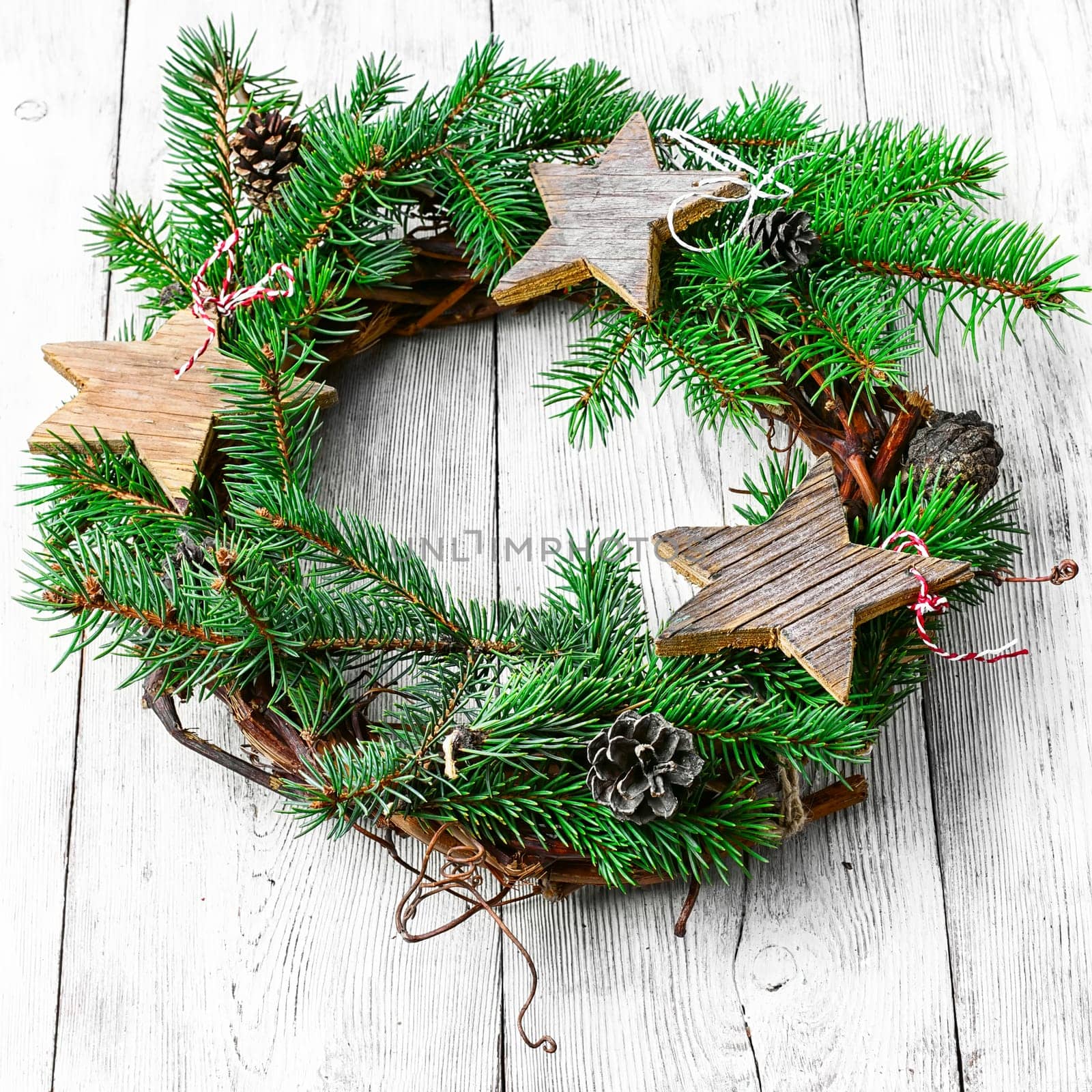 Noel wreath of fir branches decorated with Christmas toys