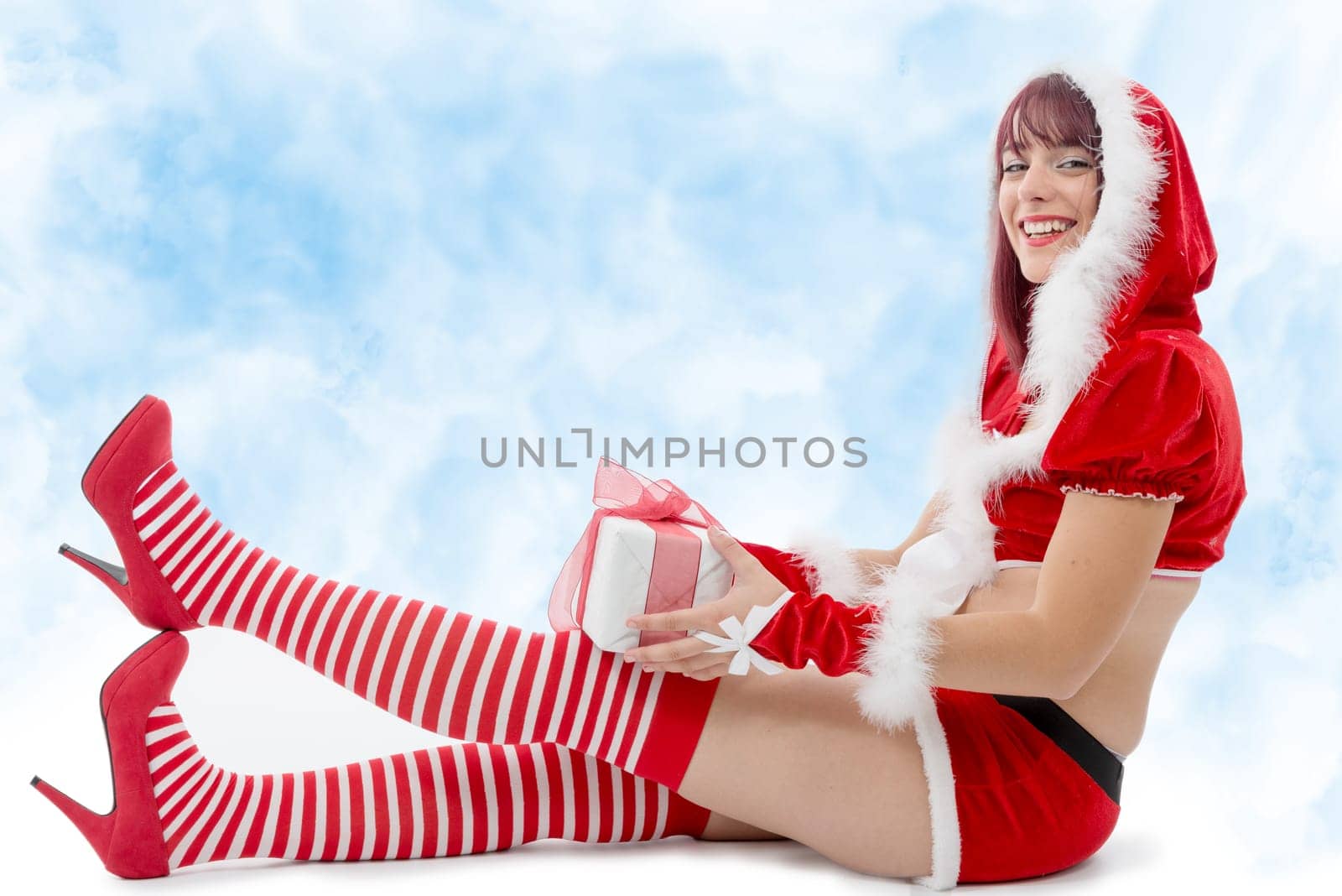 pretty young girl dressed as Santa on the floor