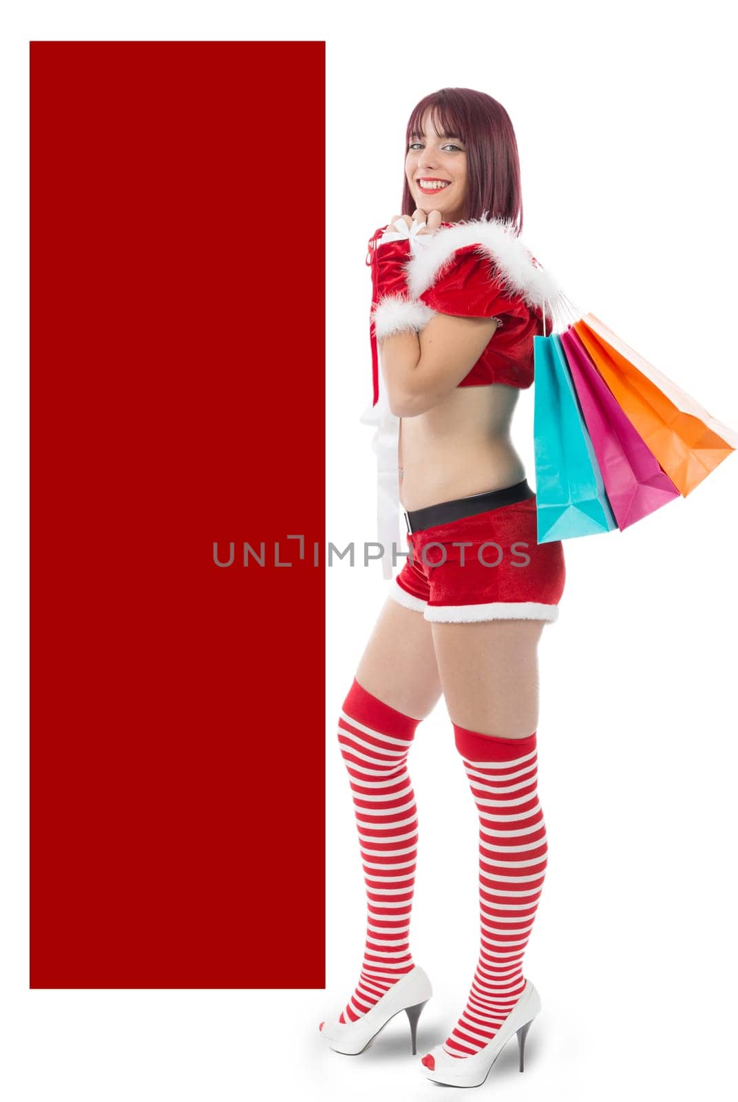 beautiful sexy girl dressed like Santa with Christmas presents