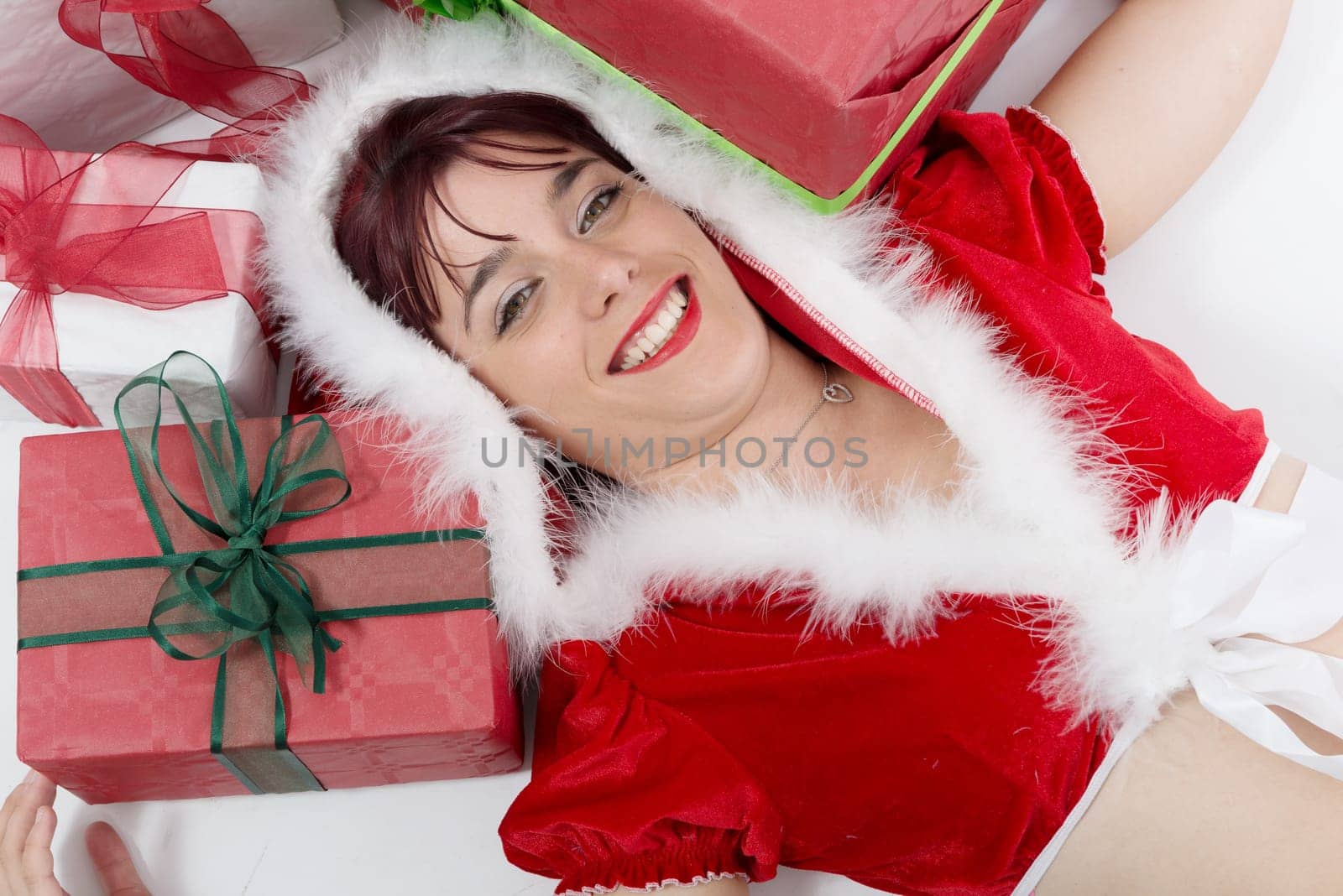 beautiful  smiling girl dressed like Santa with Christmas presents