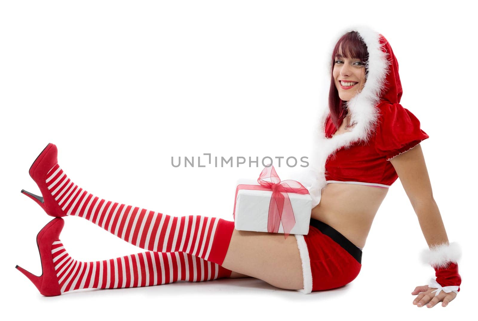 pretty young girl dressed as Santa on the floor