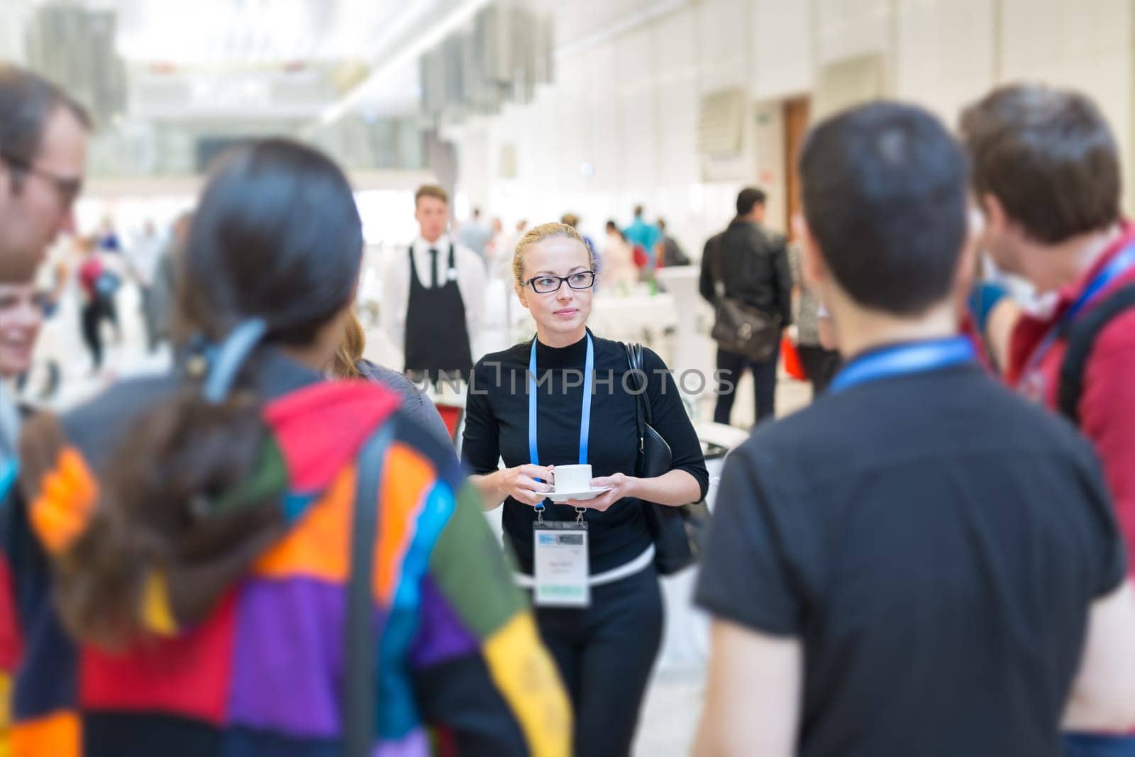People interacting during coffee break at medical or scientific conference.