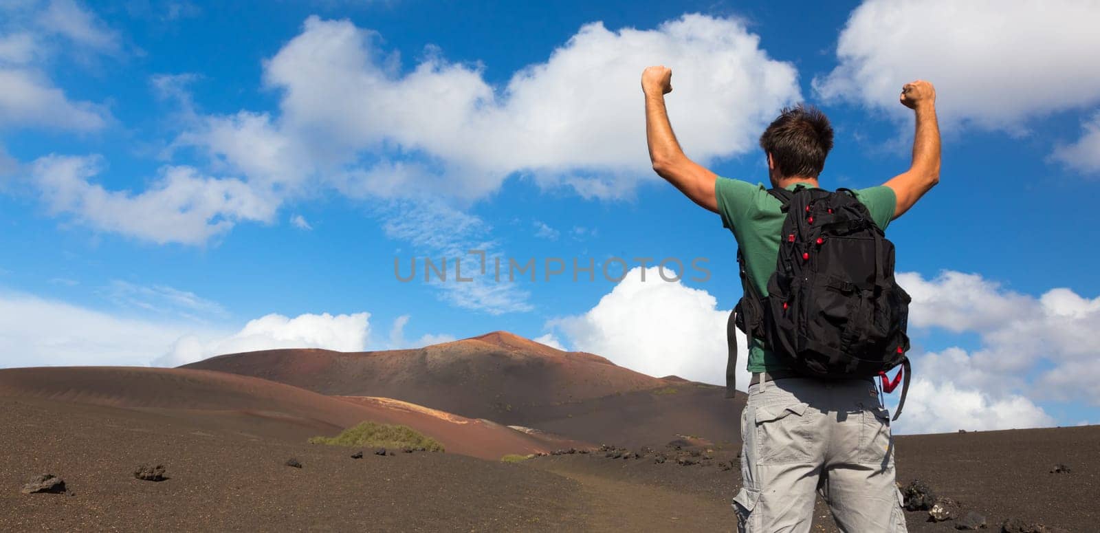 Man can see the peak of volcano, nearly made it to top. Conceptual of success. Made it. Cloce to reaching the goal.