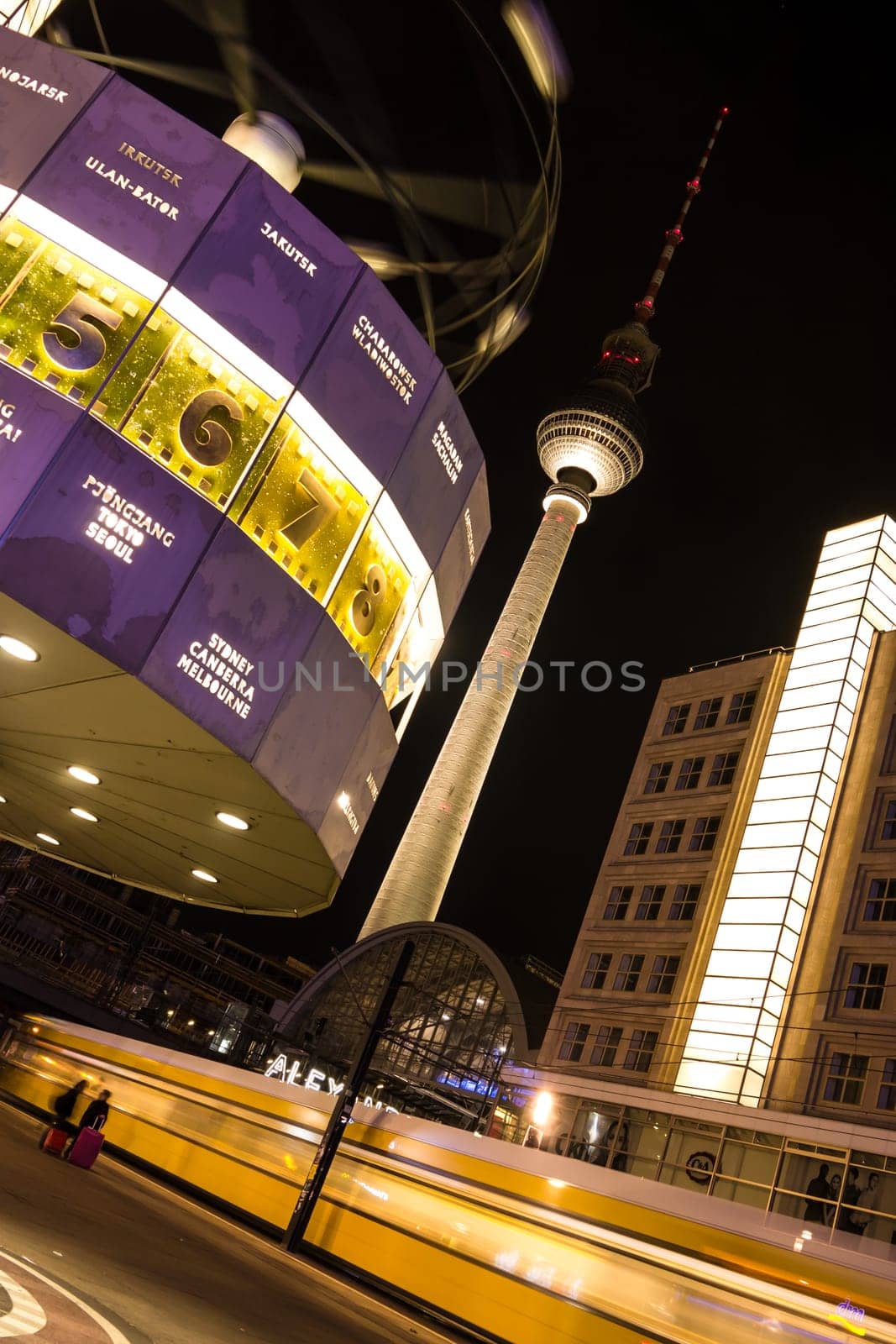 World clock, tv tower and train in berlin by night