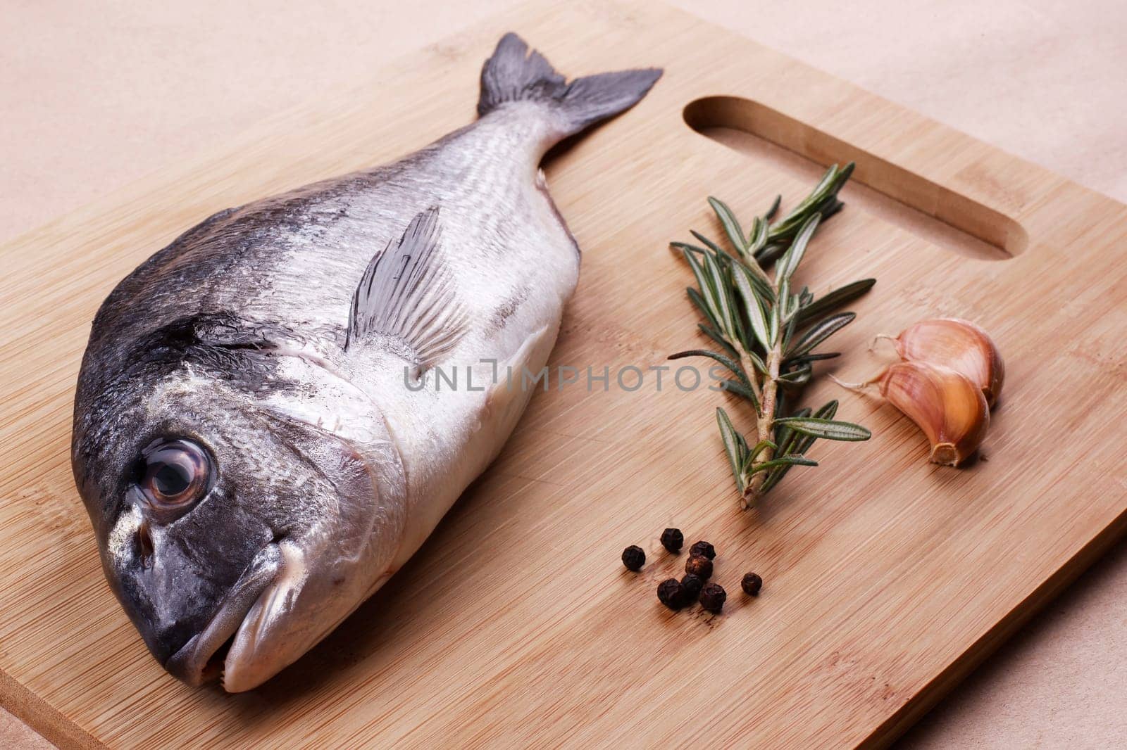 Fresh dorado seafood on a wooden plank - Stock image