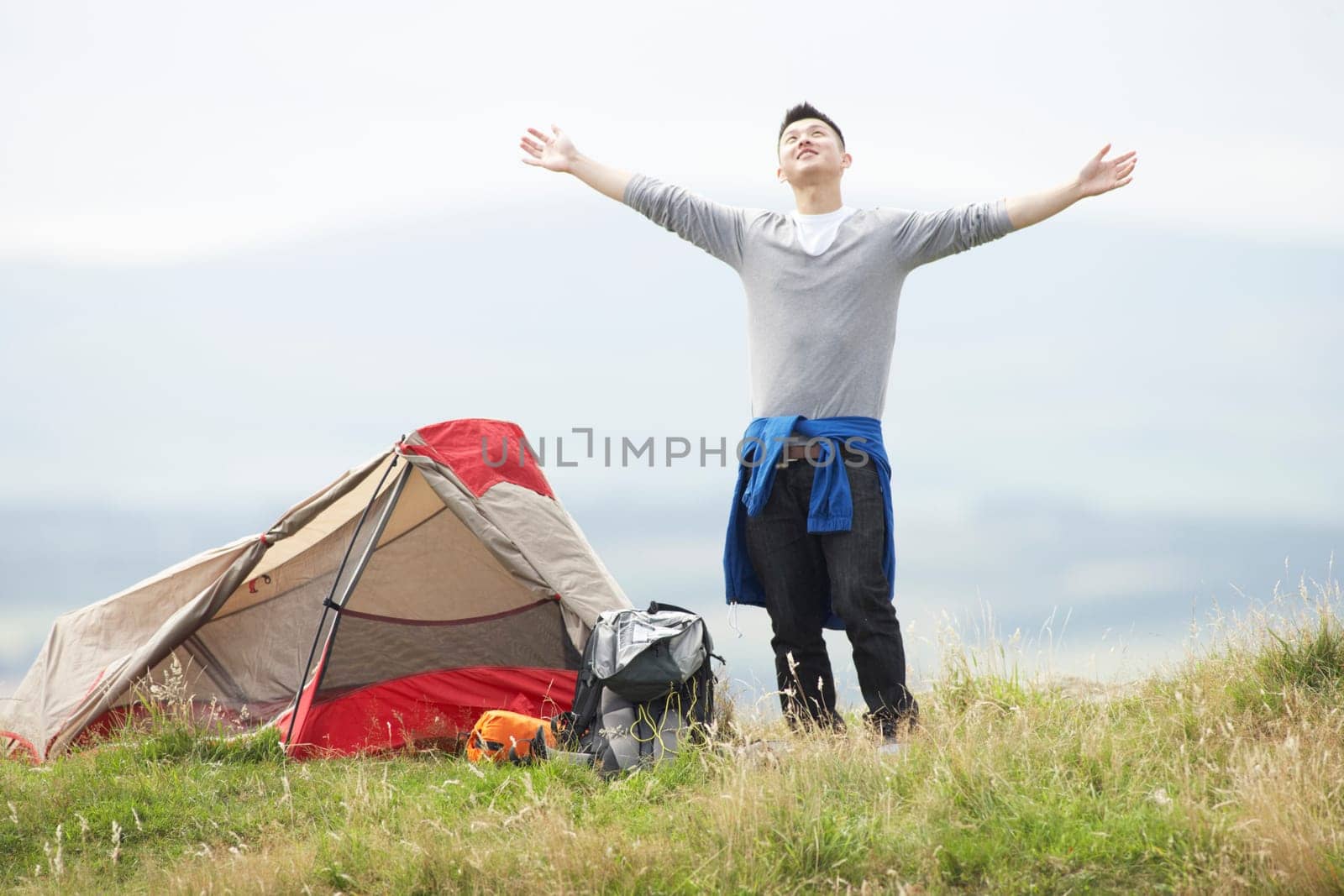 Young Man On Camping Trip In Countryside