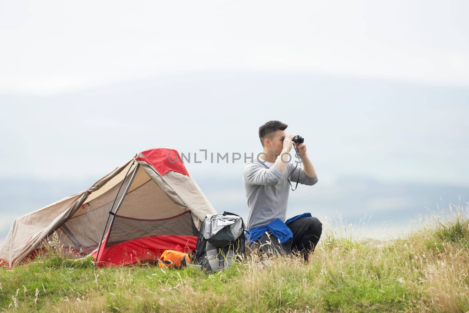 Young Man On Camping Trip In Countryside