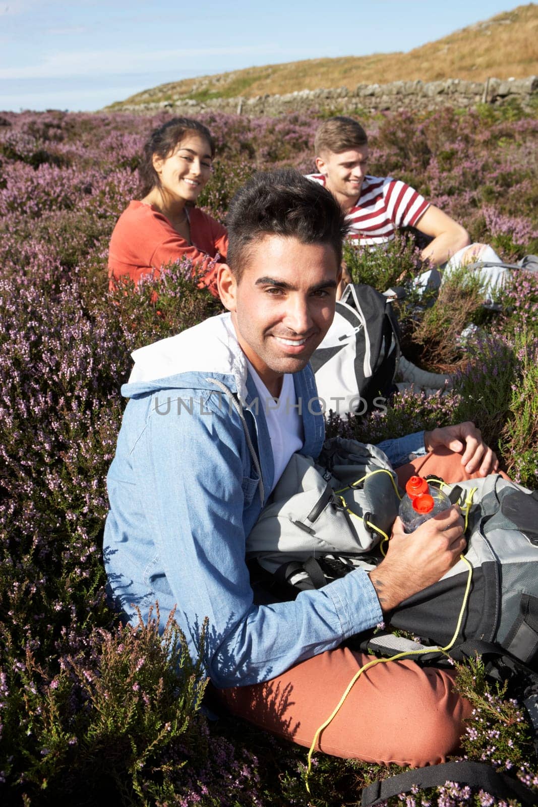 Group Of Young People Taking Break On Hike