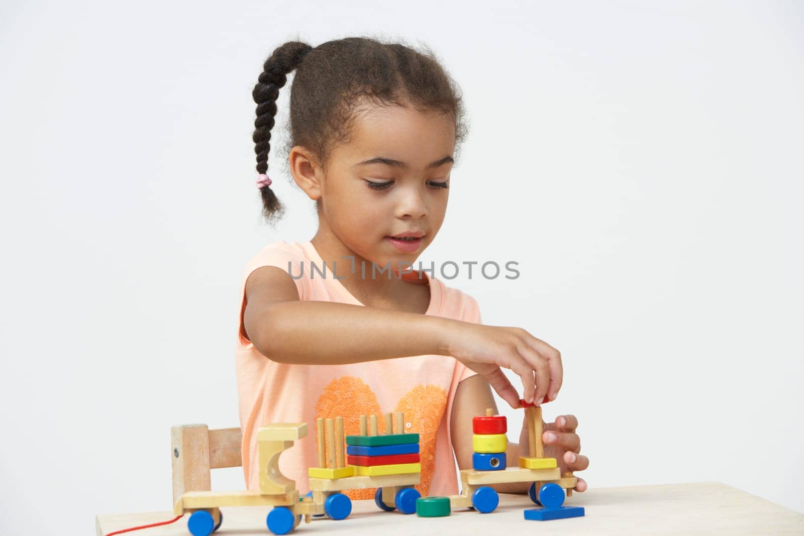 Pre-School Pupil Playing With Wooden Toy Train