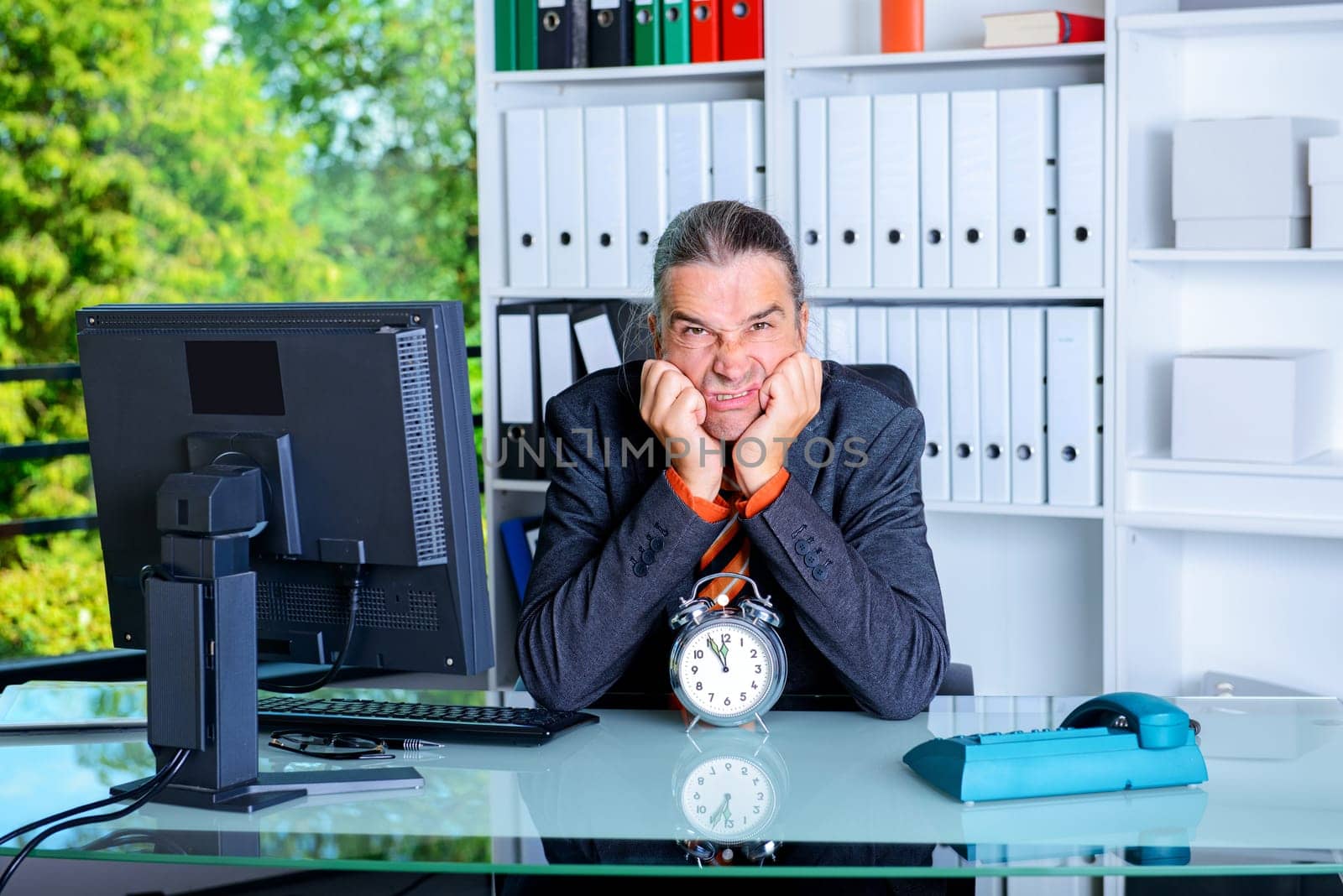 sad business man in office with clock