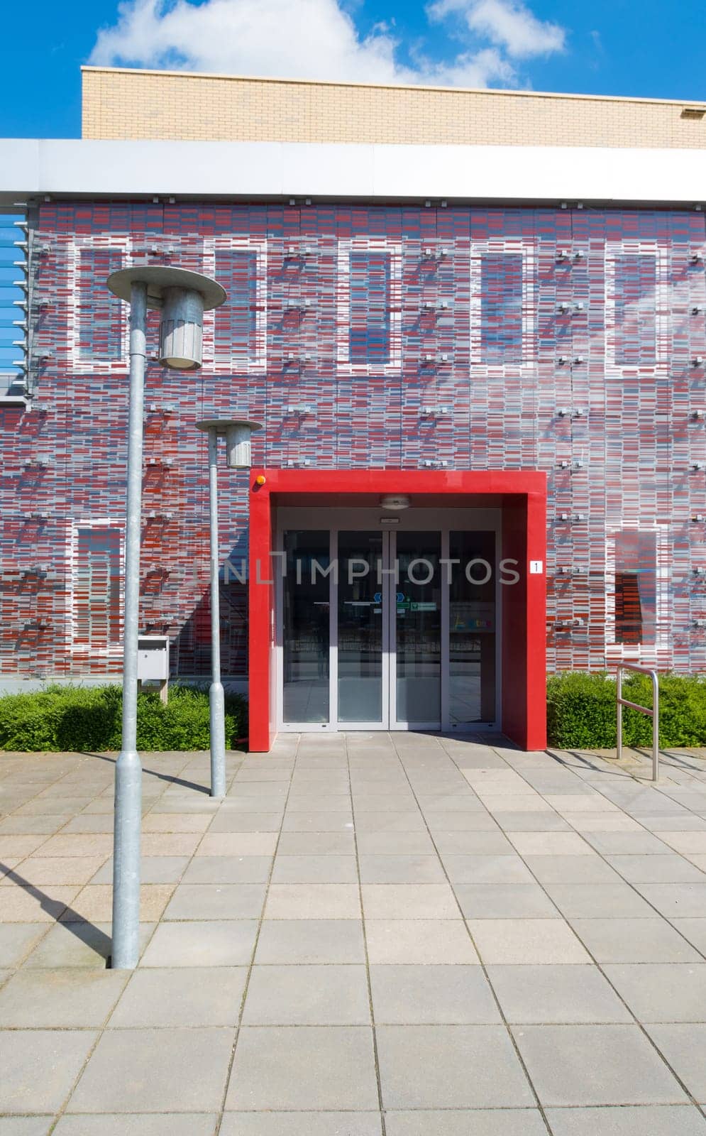 red entrance of a small modern office building