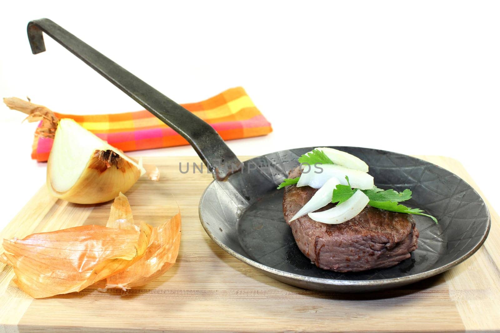 a piece of ostrich meat in an iron pan