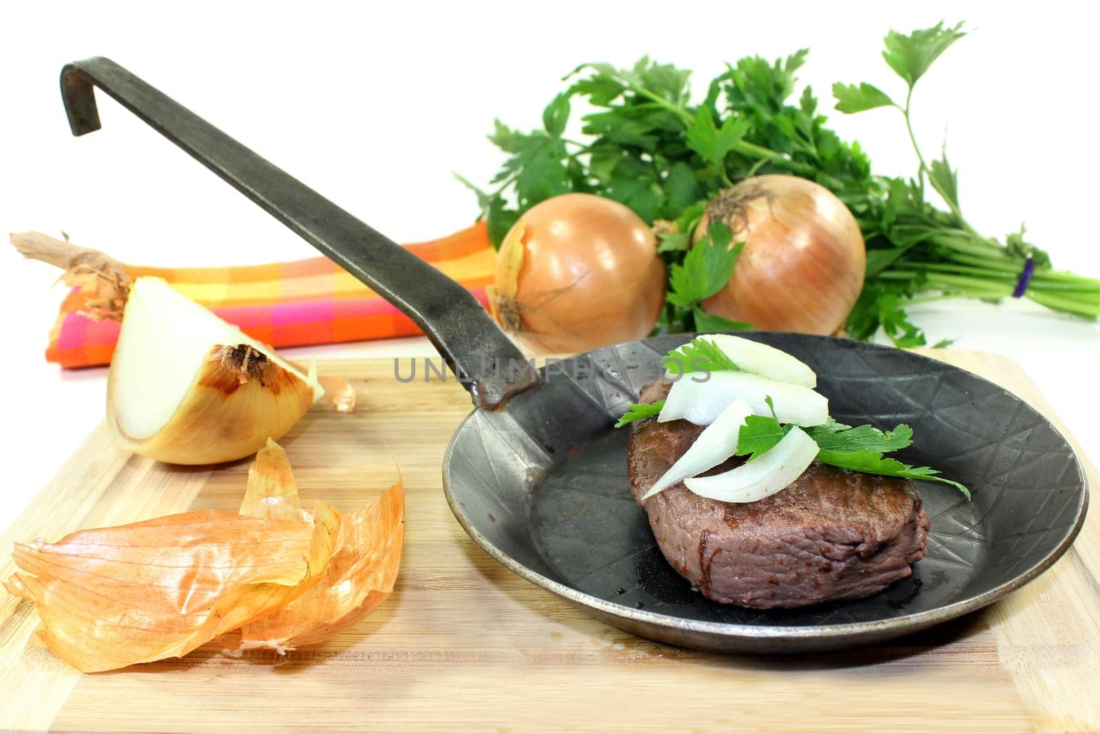 a piece of ostrich meat in an iron pan