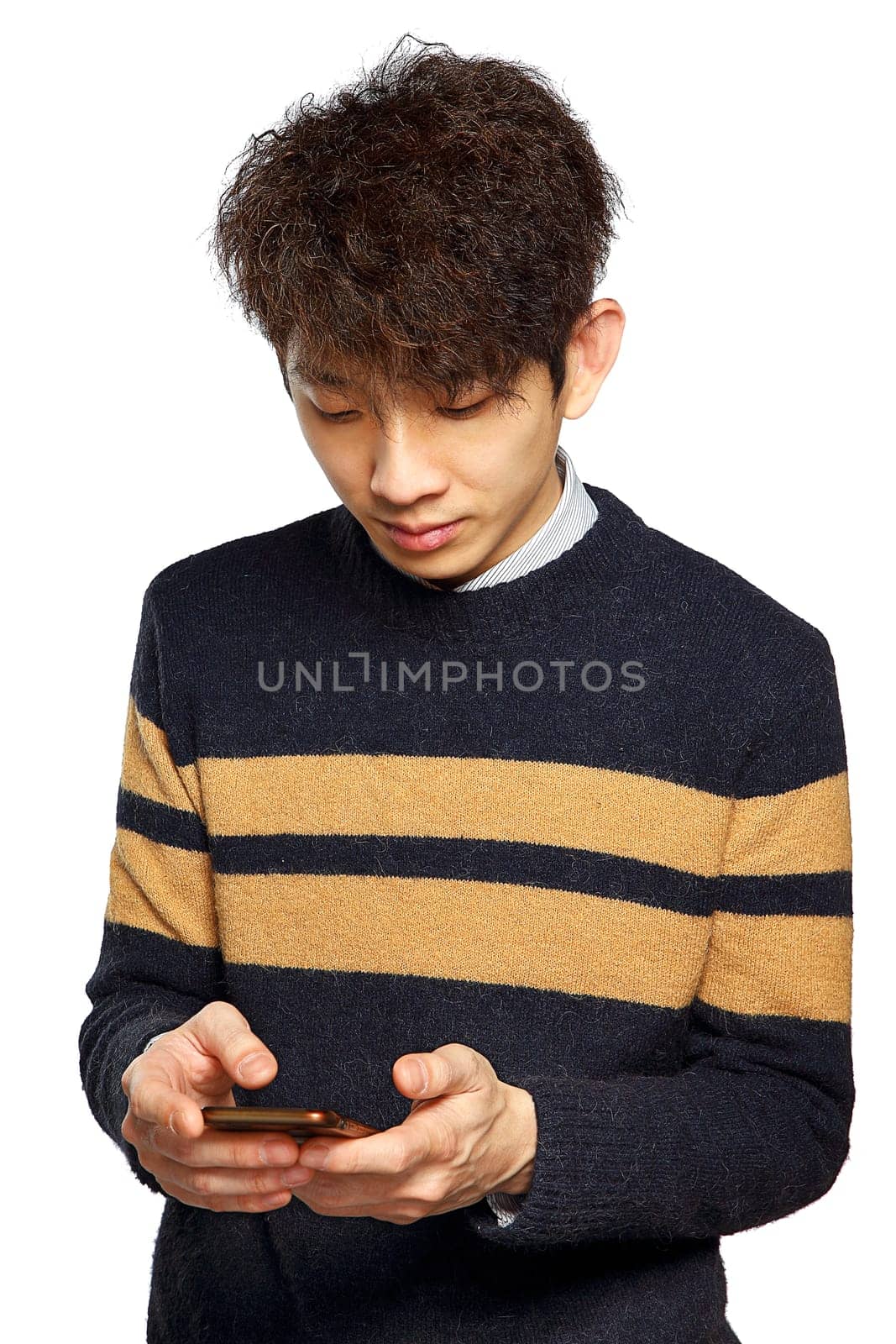 young asia man texting on mobilephone, thinking and looking away.
