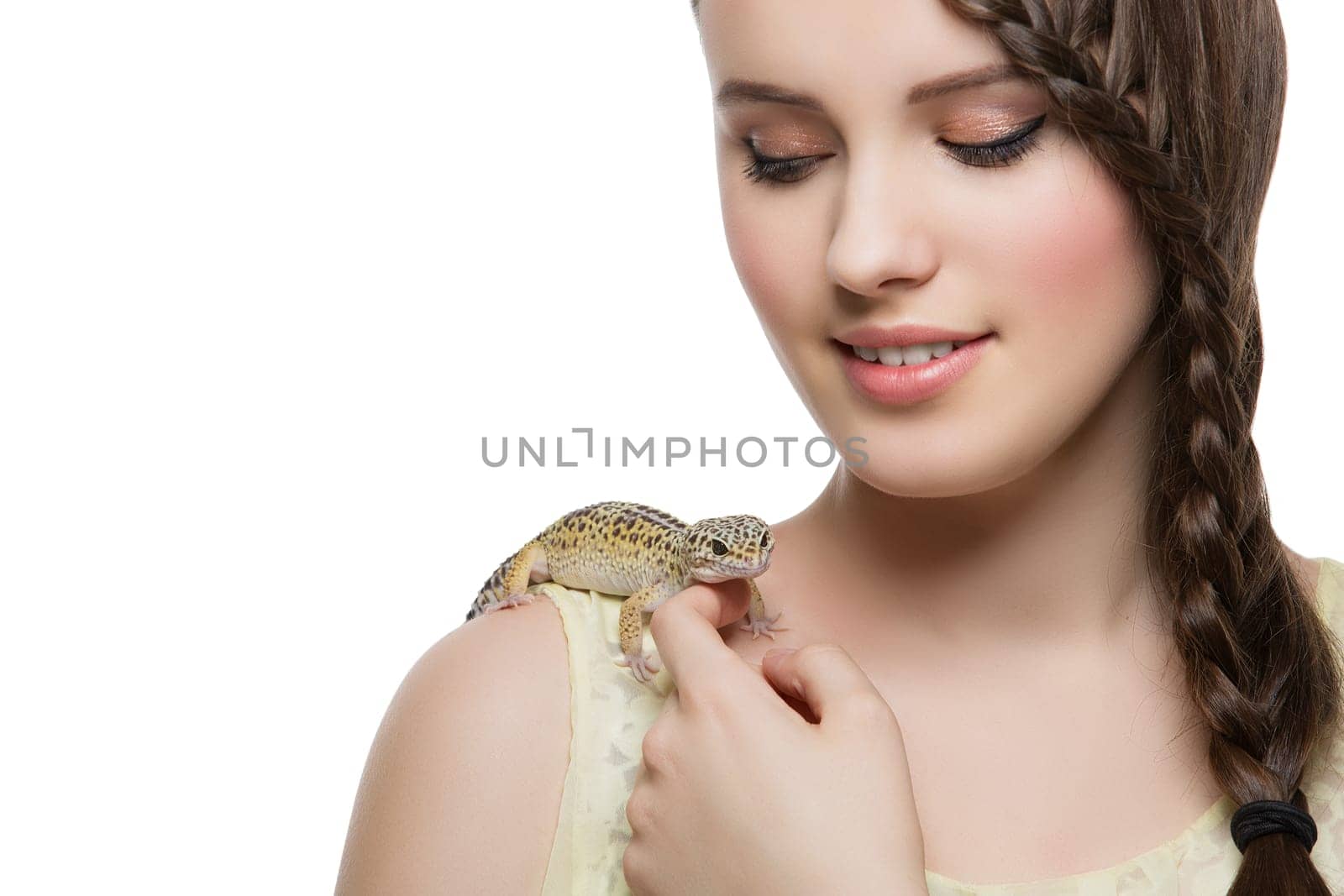 Closeup of beautiful teen girl with pet lizard sitting on her shoulder. Isolated over white background. Copy space.