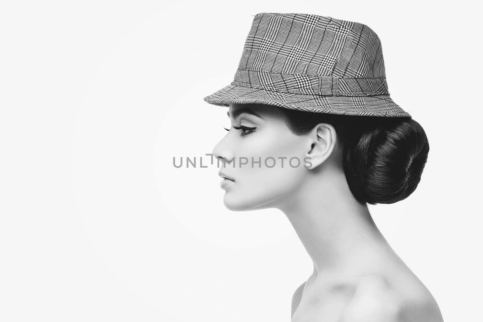 Profile of beautiful young woman with long neck wearing stylish hat. isolated