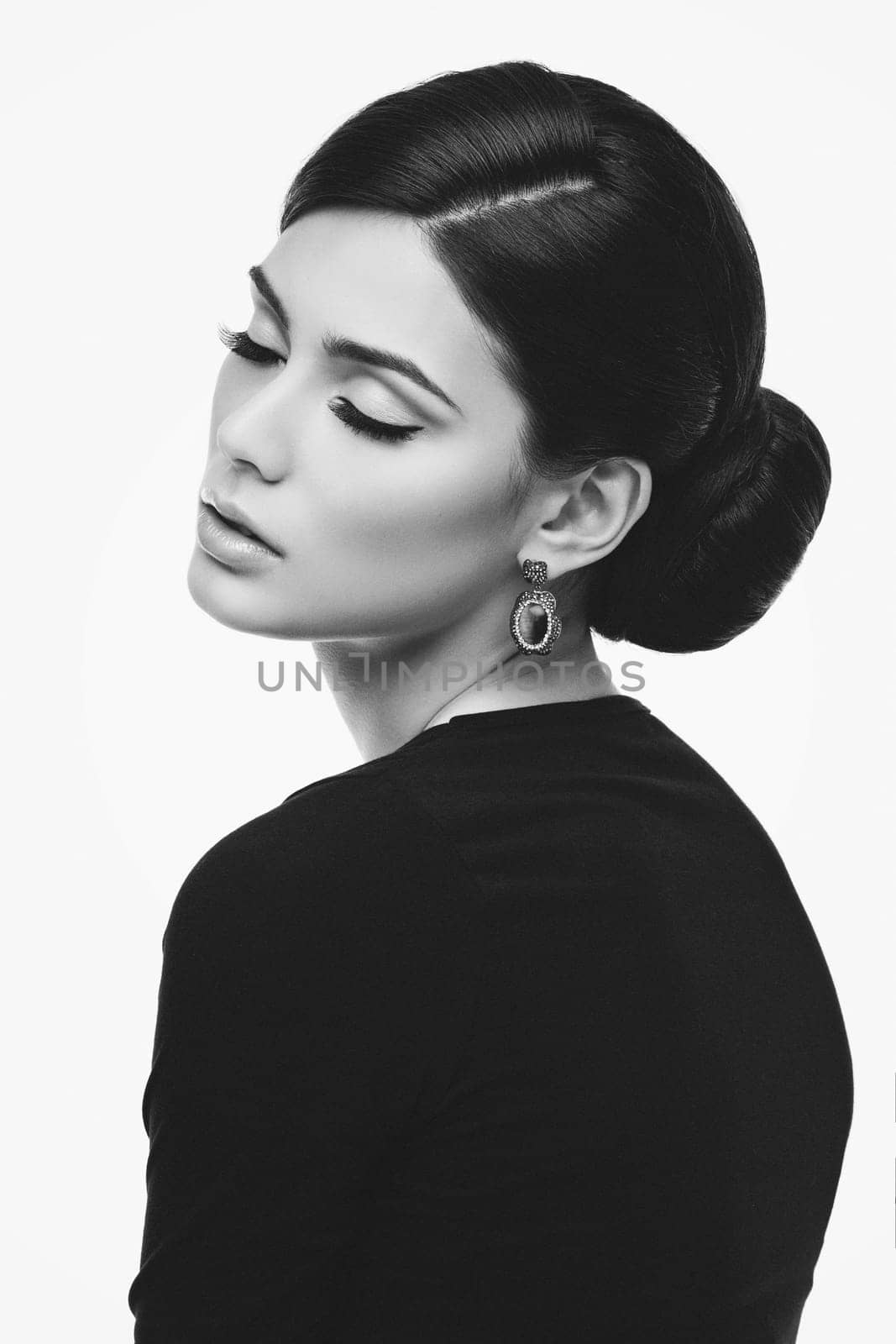 Gorgeous young woman with natural beautiful makeup and elegant hairstyle isolated over white background
