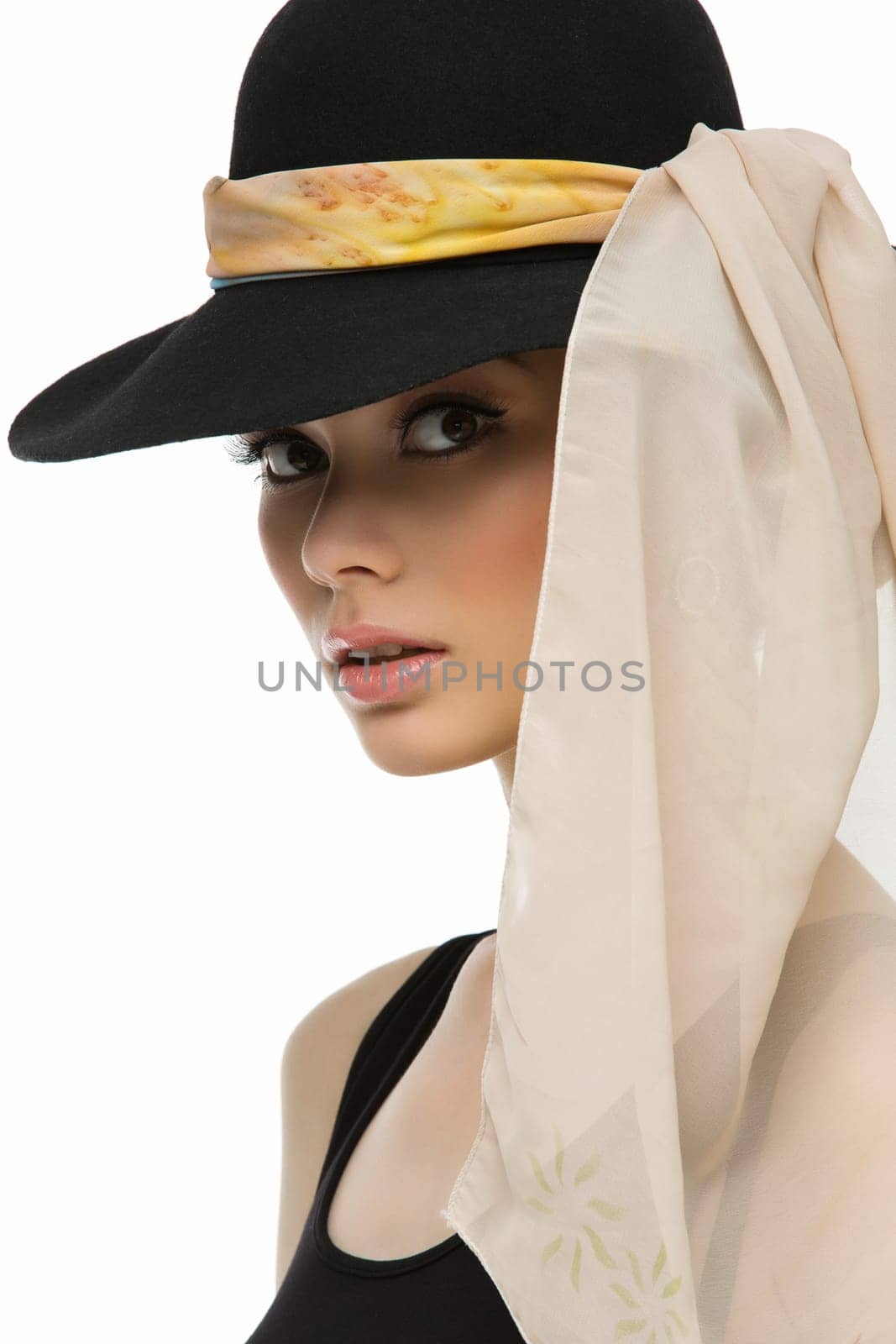 Beautiful woman looking like Audrey wearing black hat and light scarf