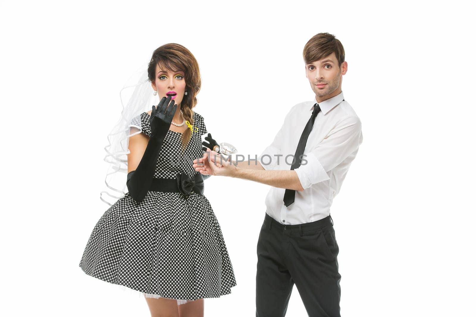 Handsome man proposing to beautiful woman. People looking like dolls. Isolated over white background. Copy space.