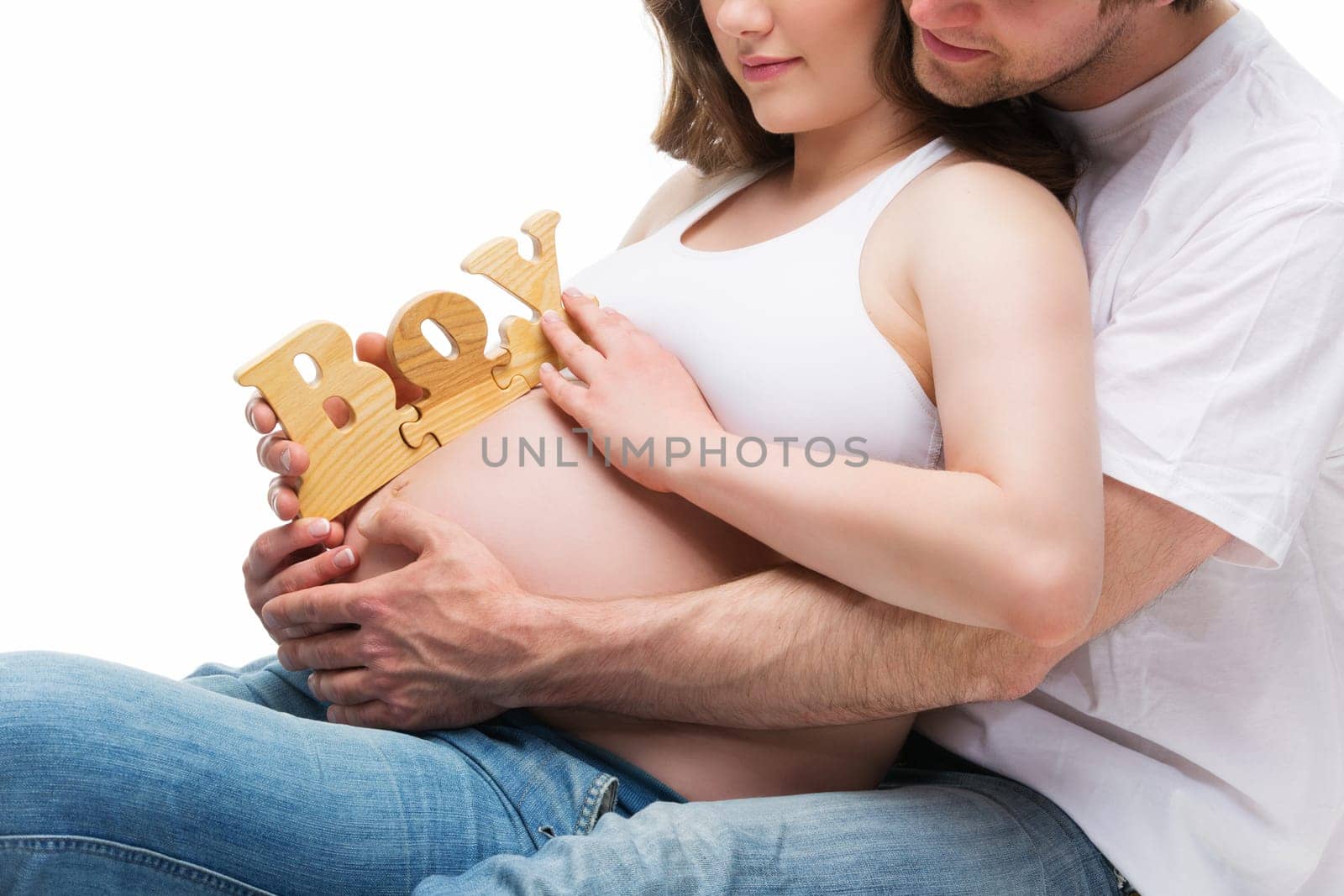 Happy and young pregnant couple hugging and expecting a baby boy