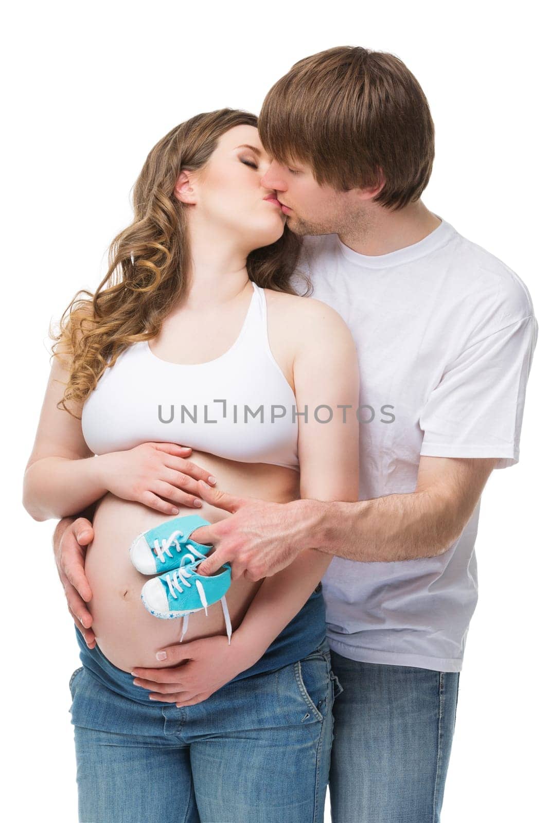 Young man kissing his pregnant wife. Future parents epecting their baby. Isolated on white background
