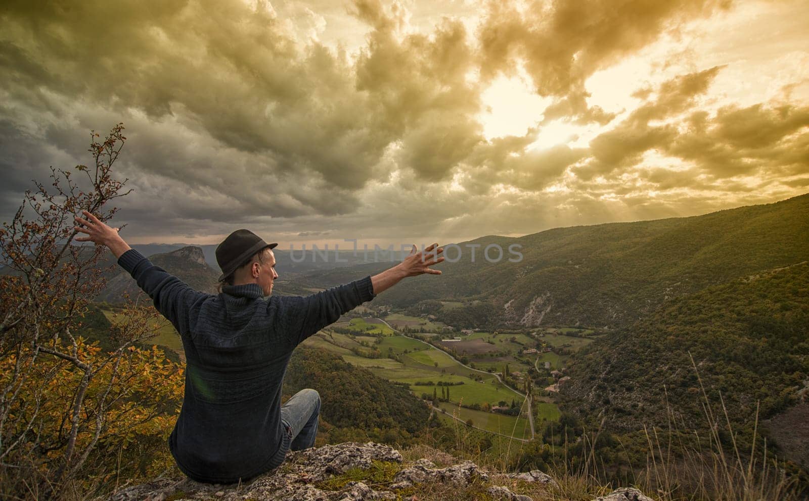 young man looking at the mountain at sunset