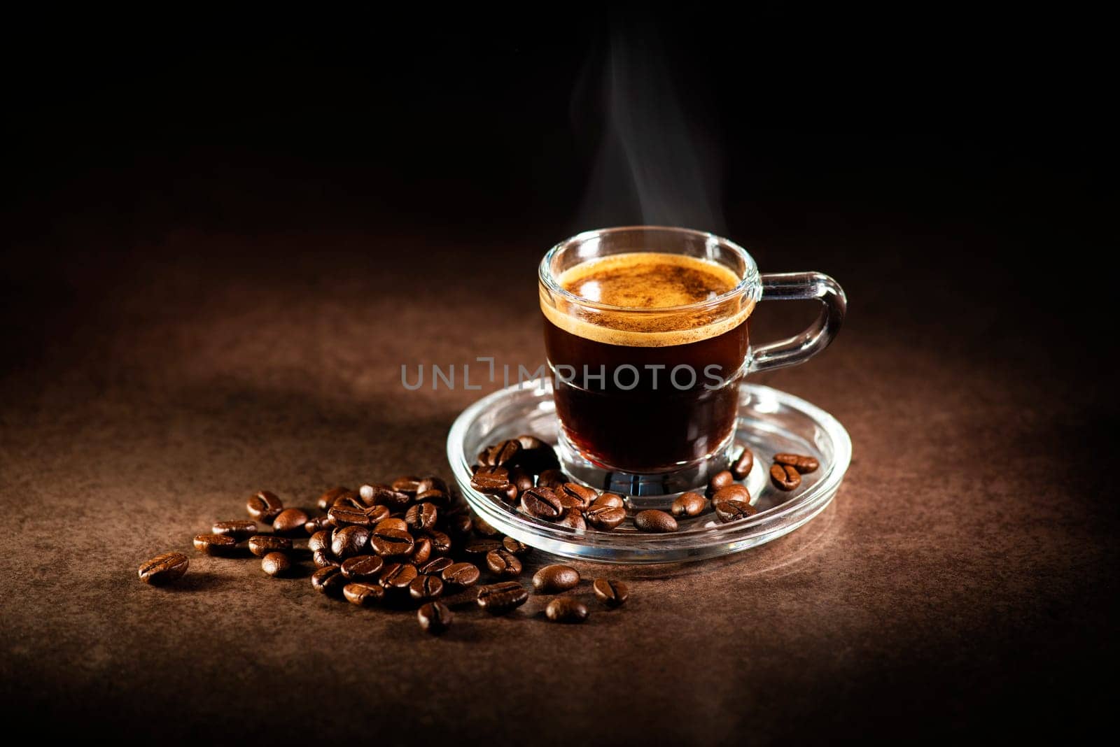Cup of espresso coffee on dark background.