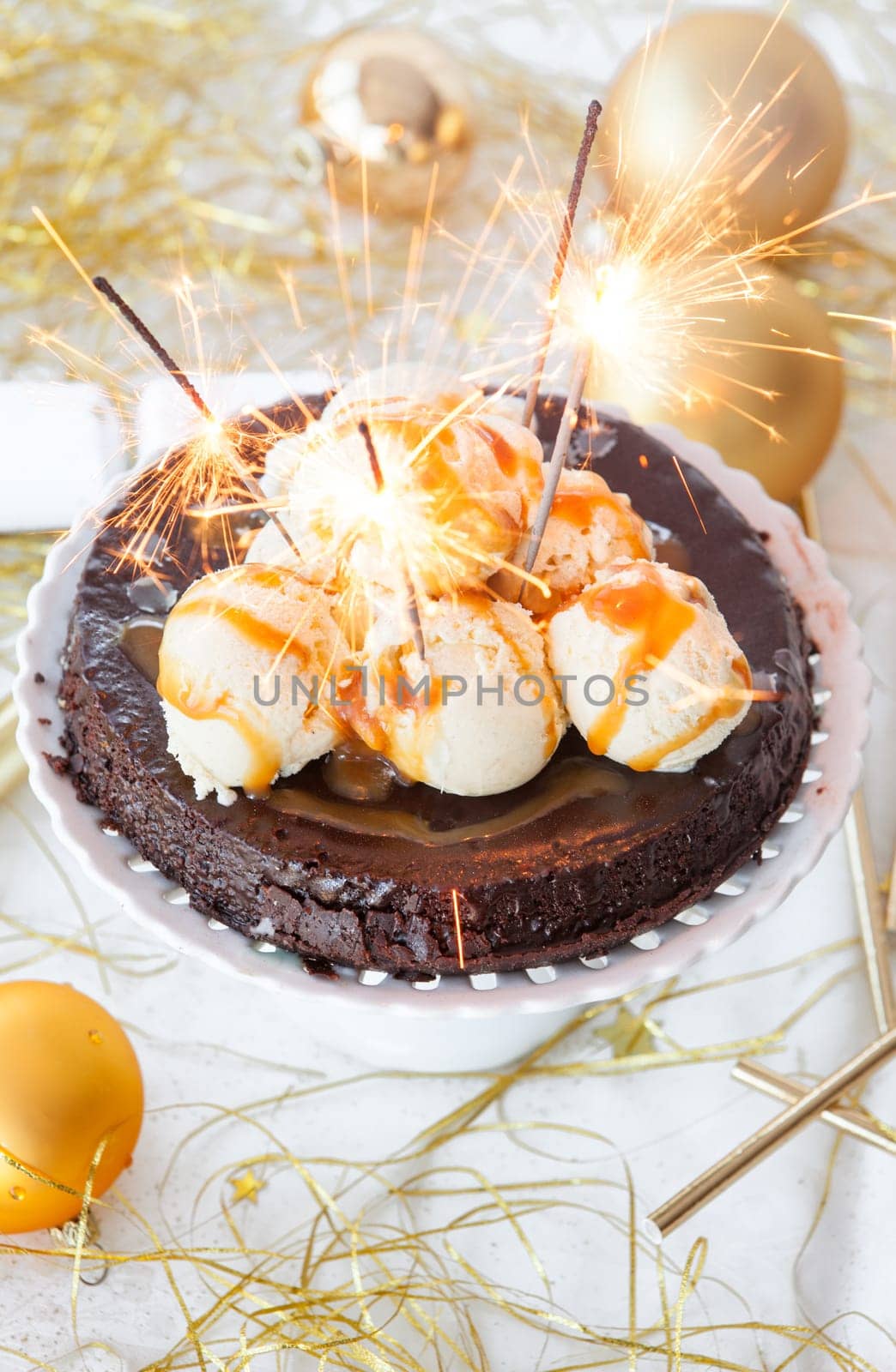 Chocolate cake with vanilla ice cream and sparklers