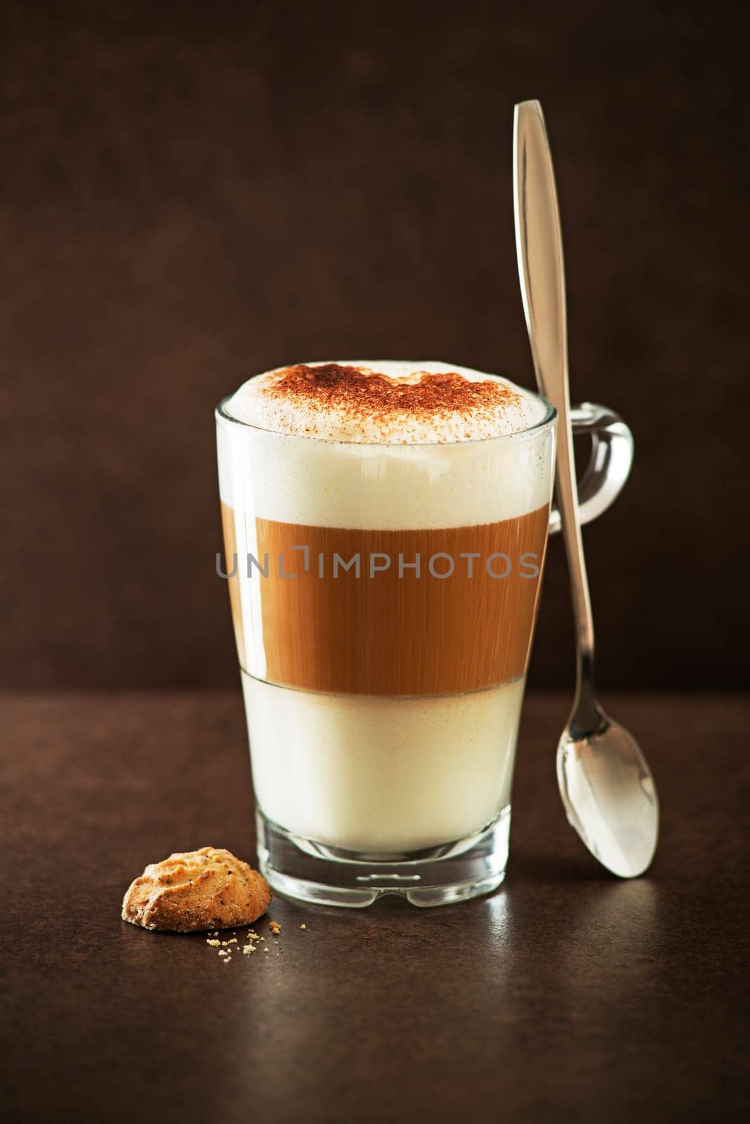 Glass of hot Latte macchiato coffee close up.