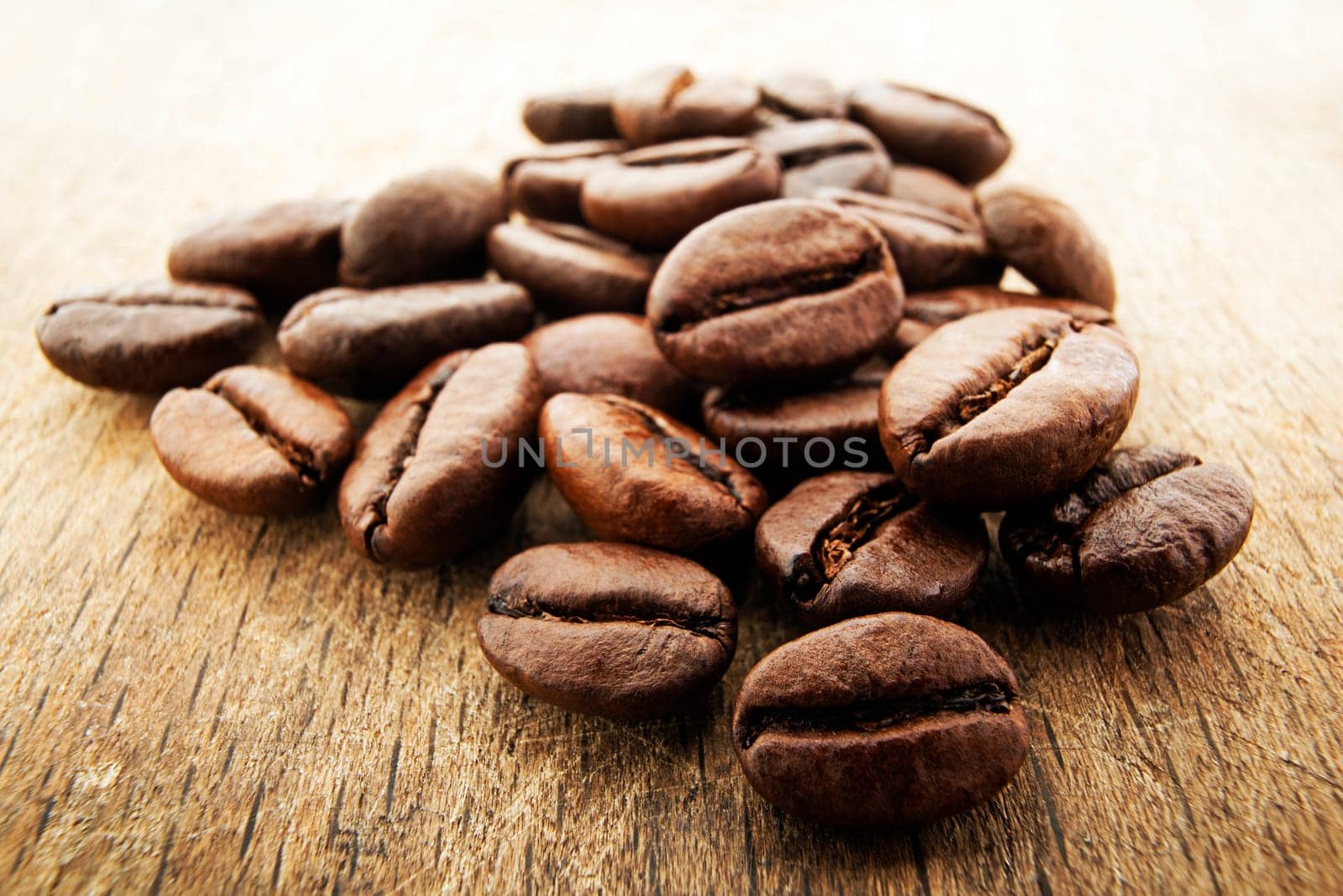 Coffee beans on a wooden background close up