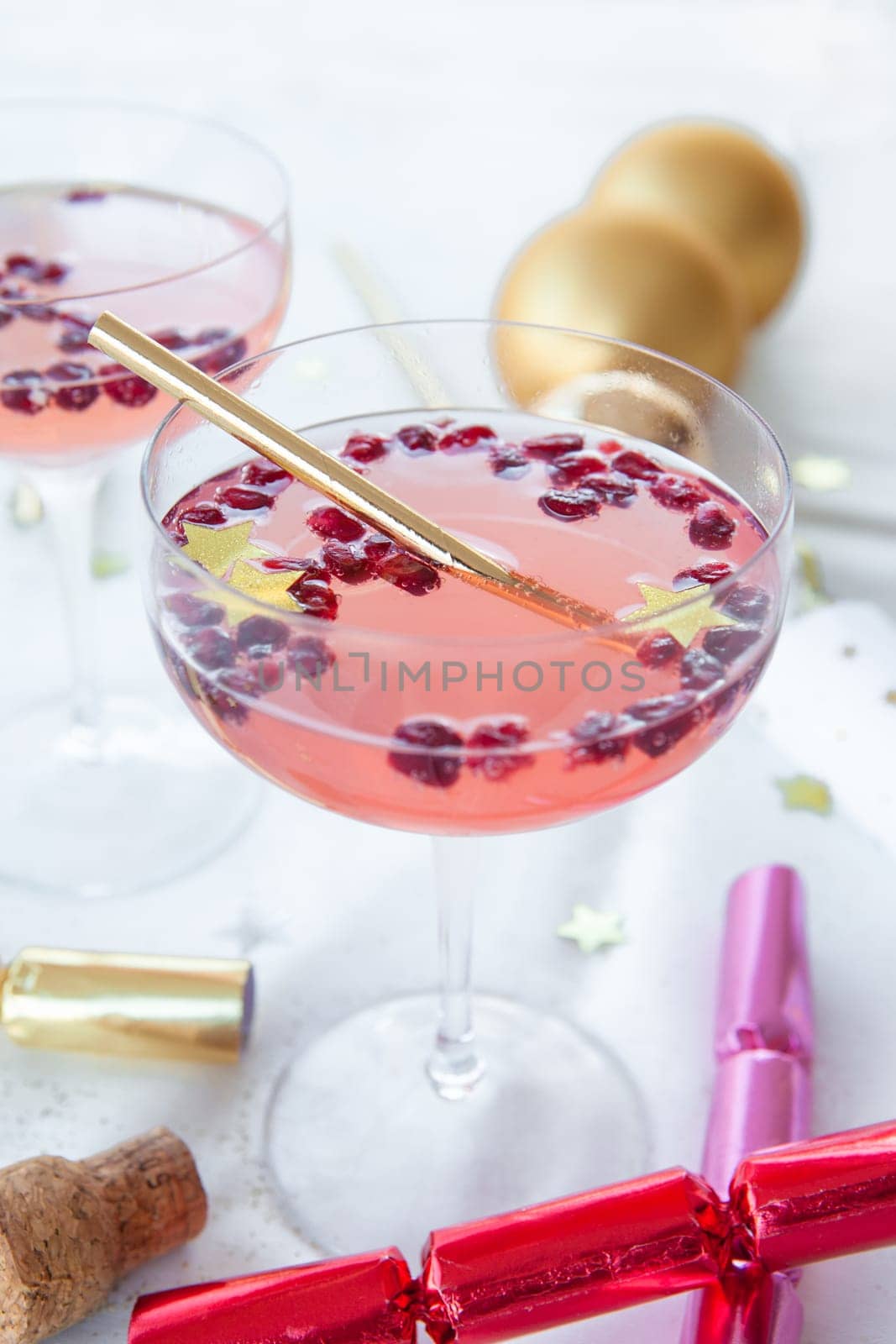 Pink cocktail with pomegranate and Christmas decorations